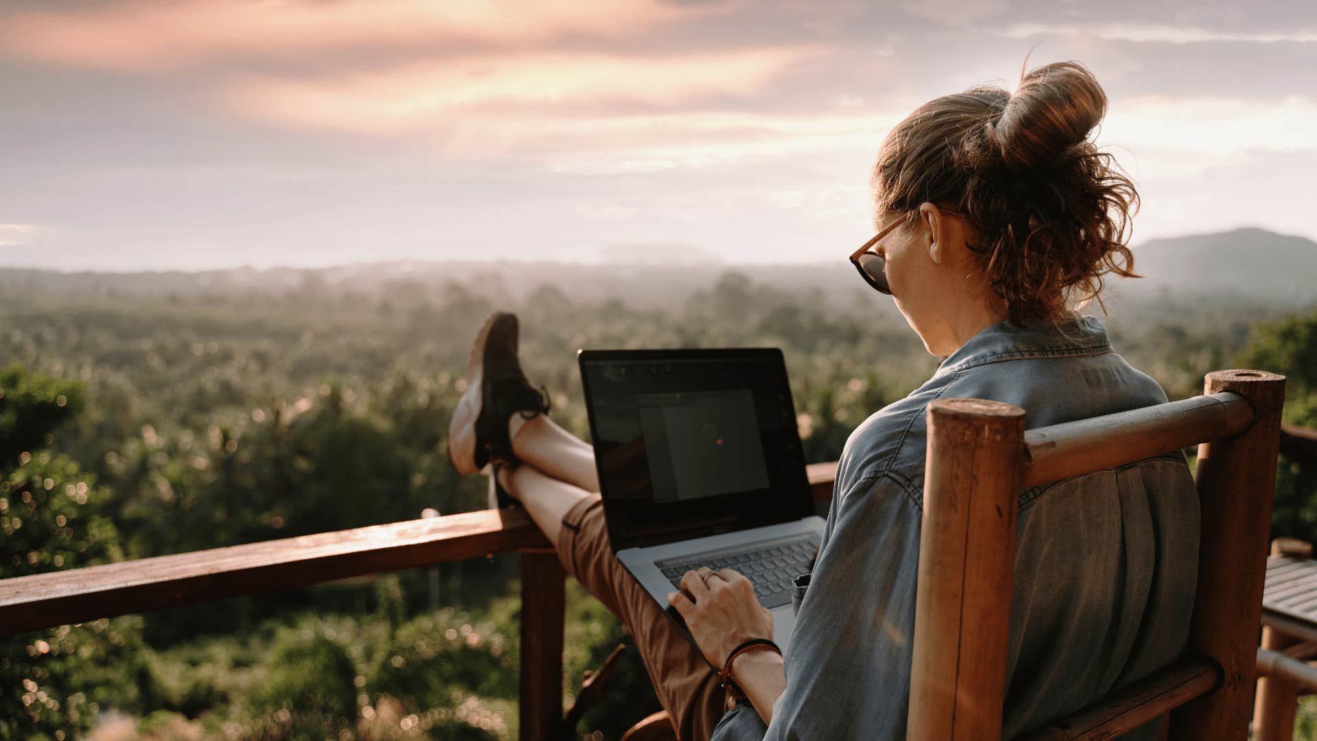 woman working from balcony thanks to her ability to follow flexible remote schedule