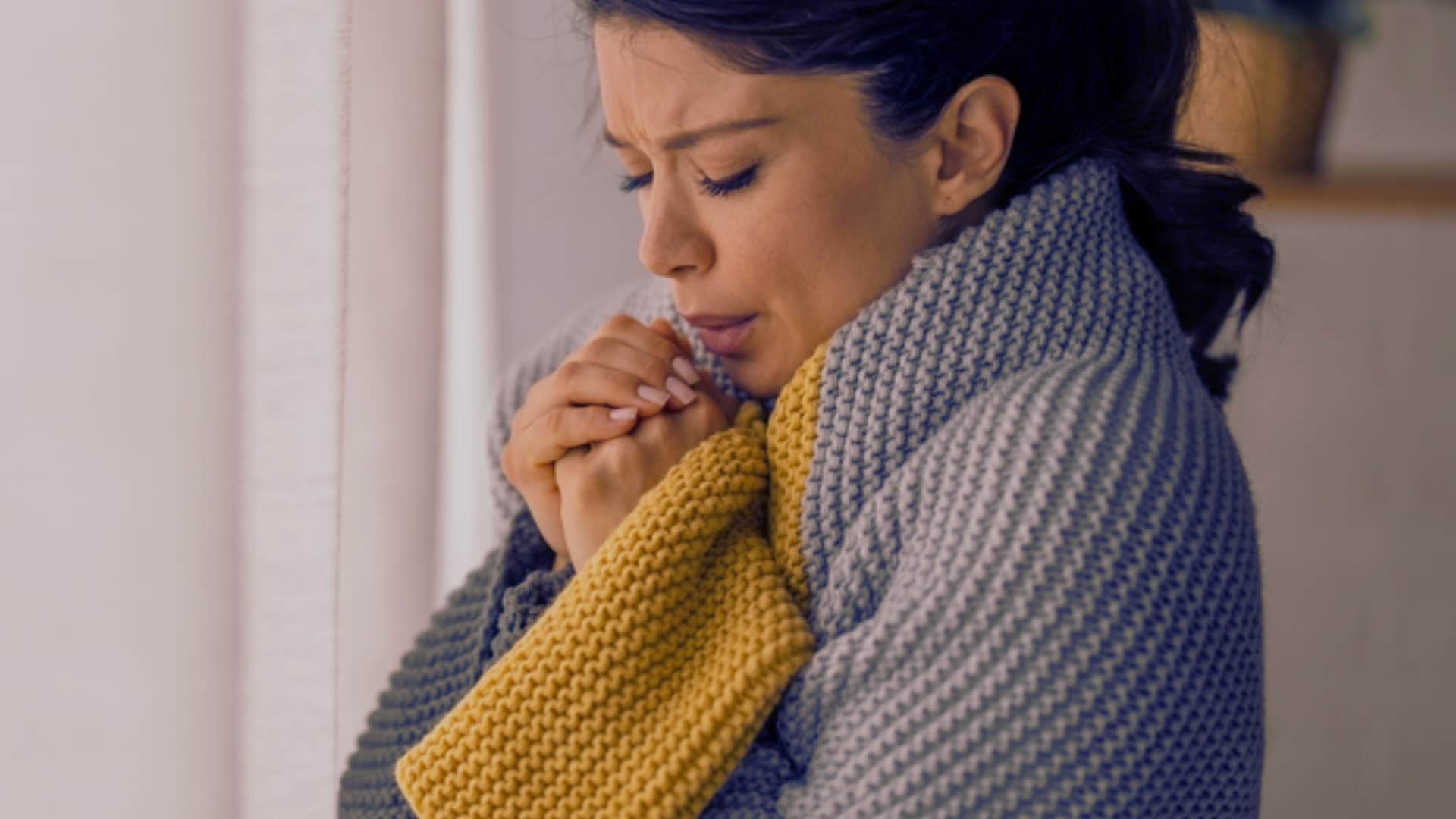 woman experiencing temperature changes in her house 