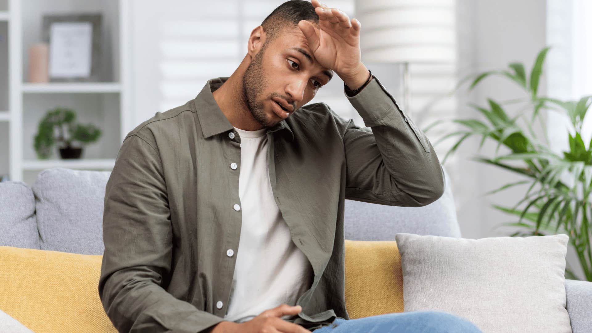 stressed man wiping his forehead