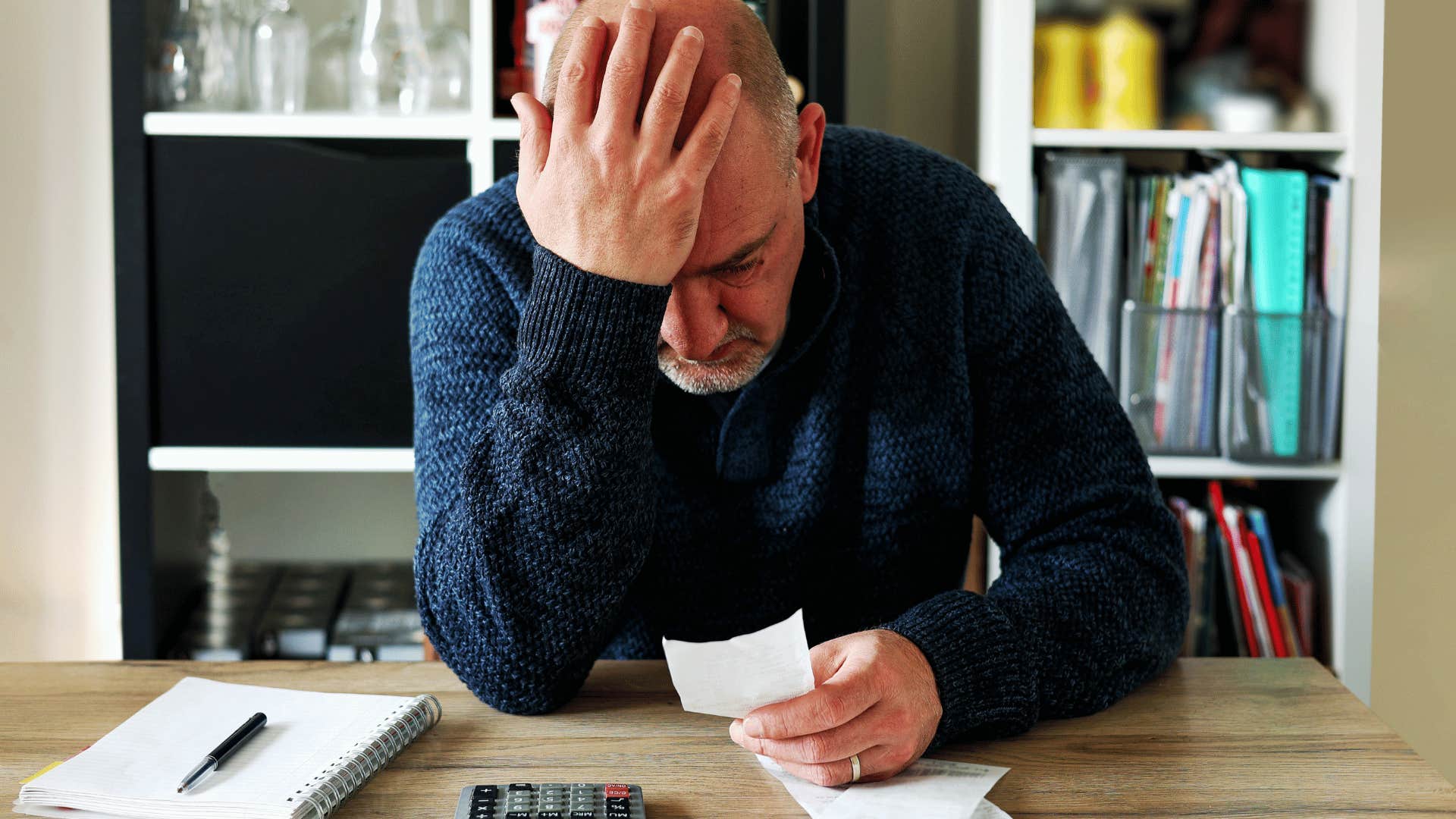 stressed upset man doing his bills