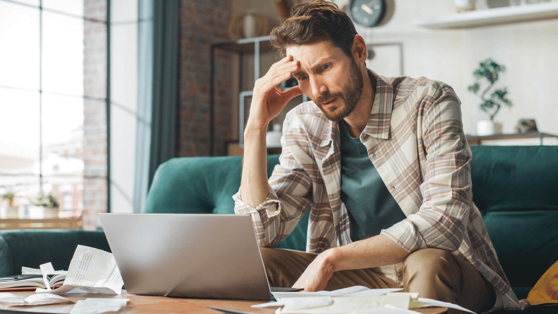 stressed man working on his laptop