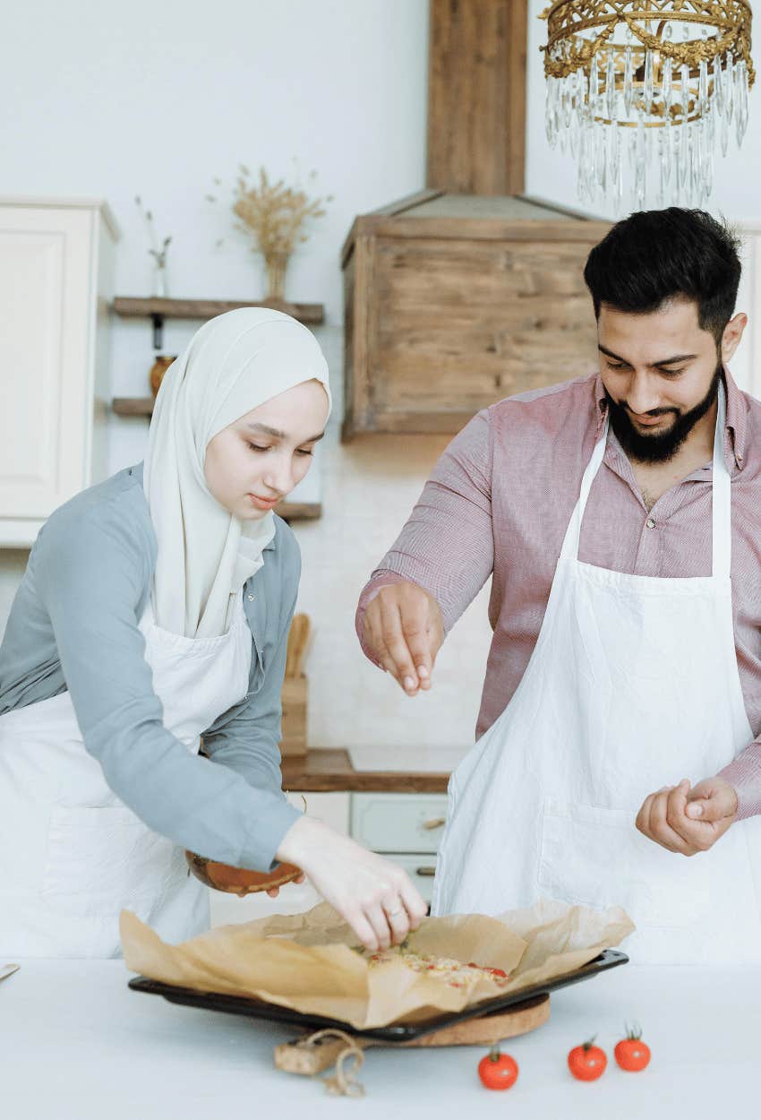 A husband makes an effort to help his wife prepare dinner.