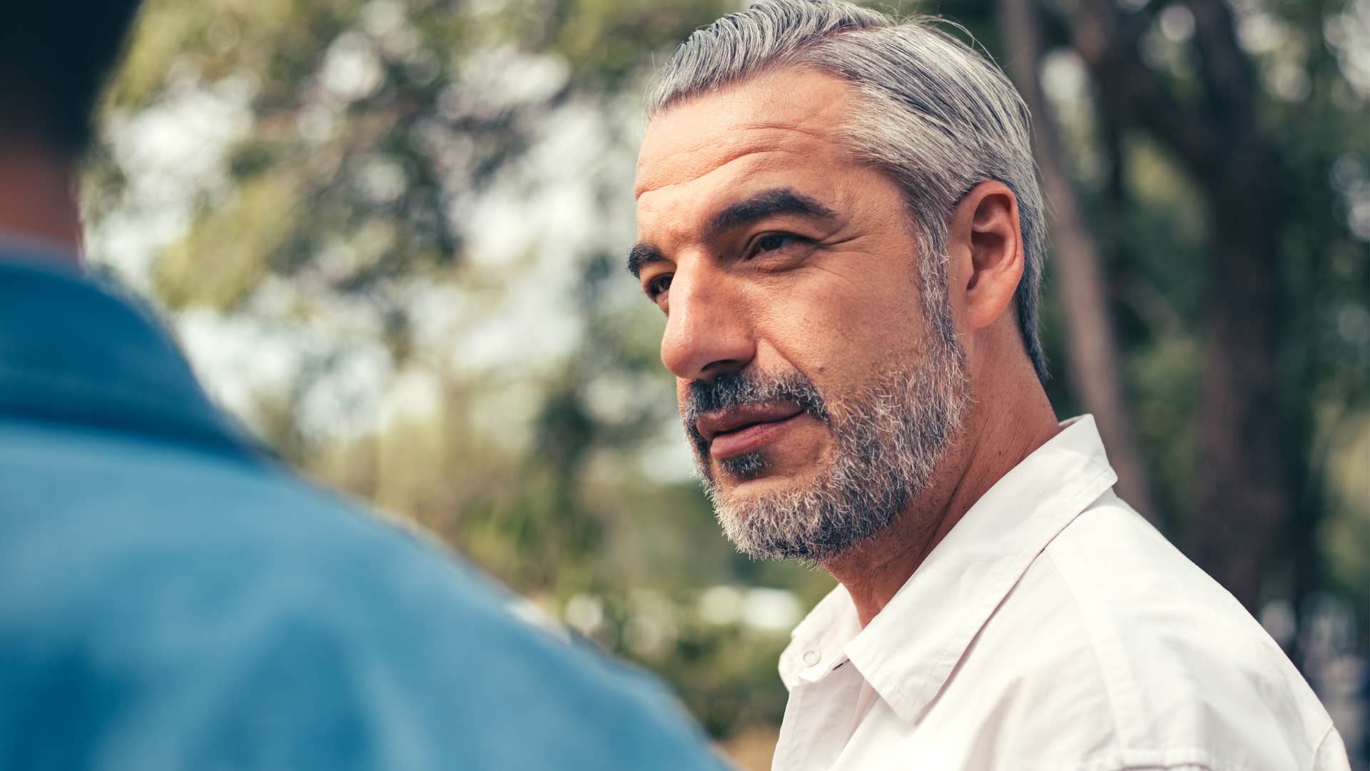 serious man reacting to son feeling unheard talking to him