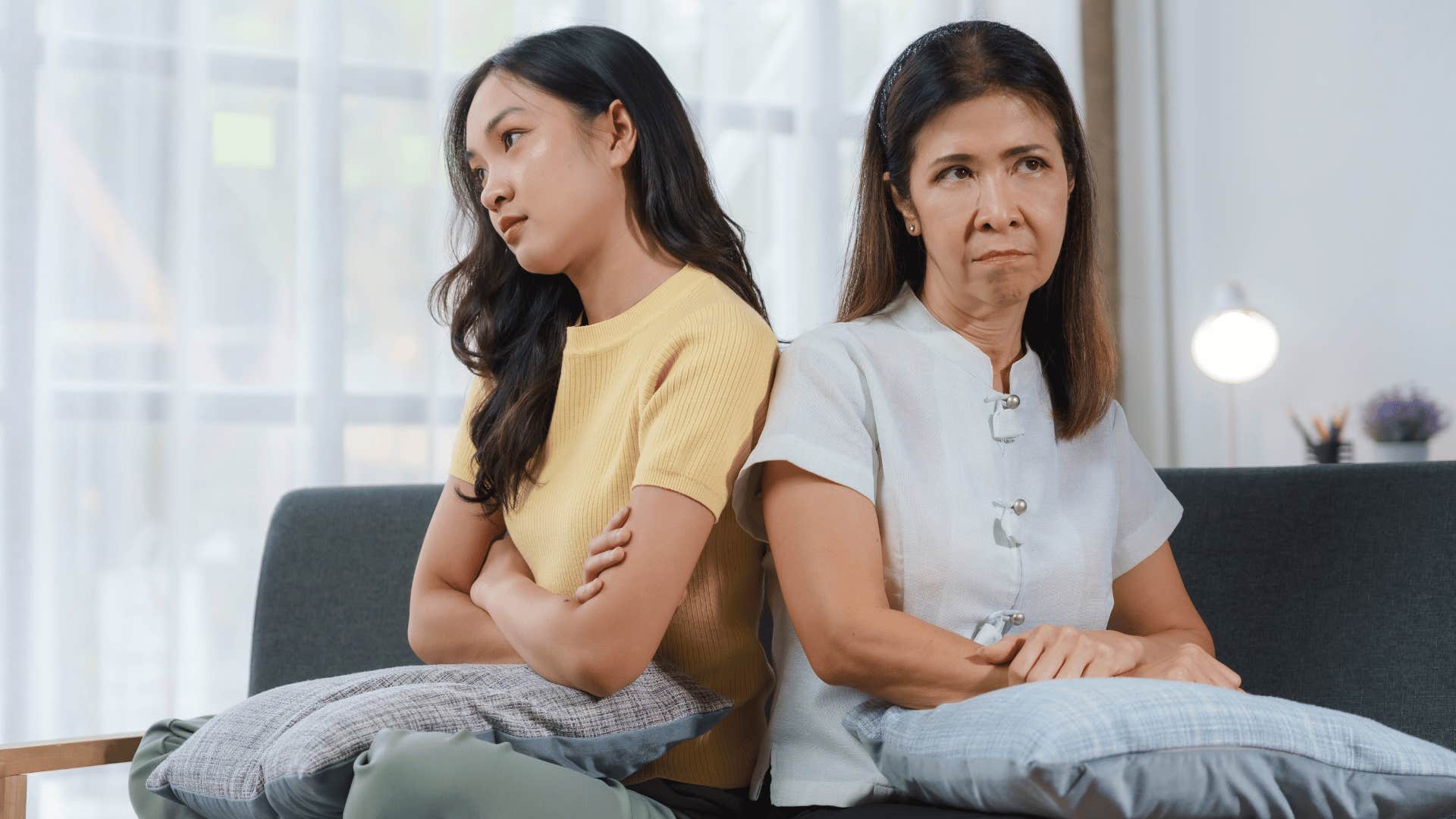 Upset adult woman who feels unheard turned away from her mom.