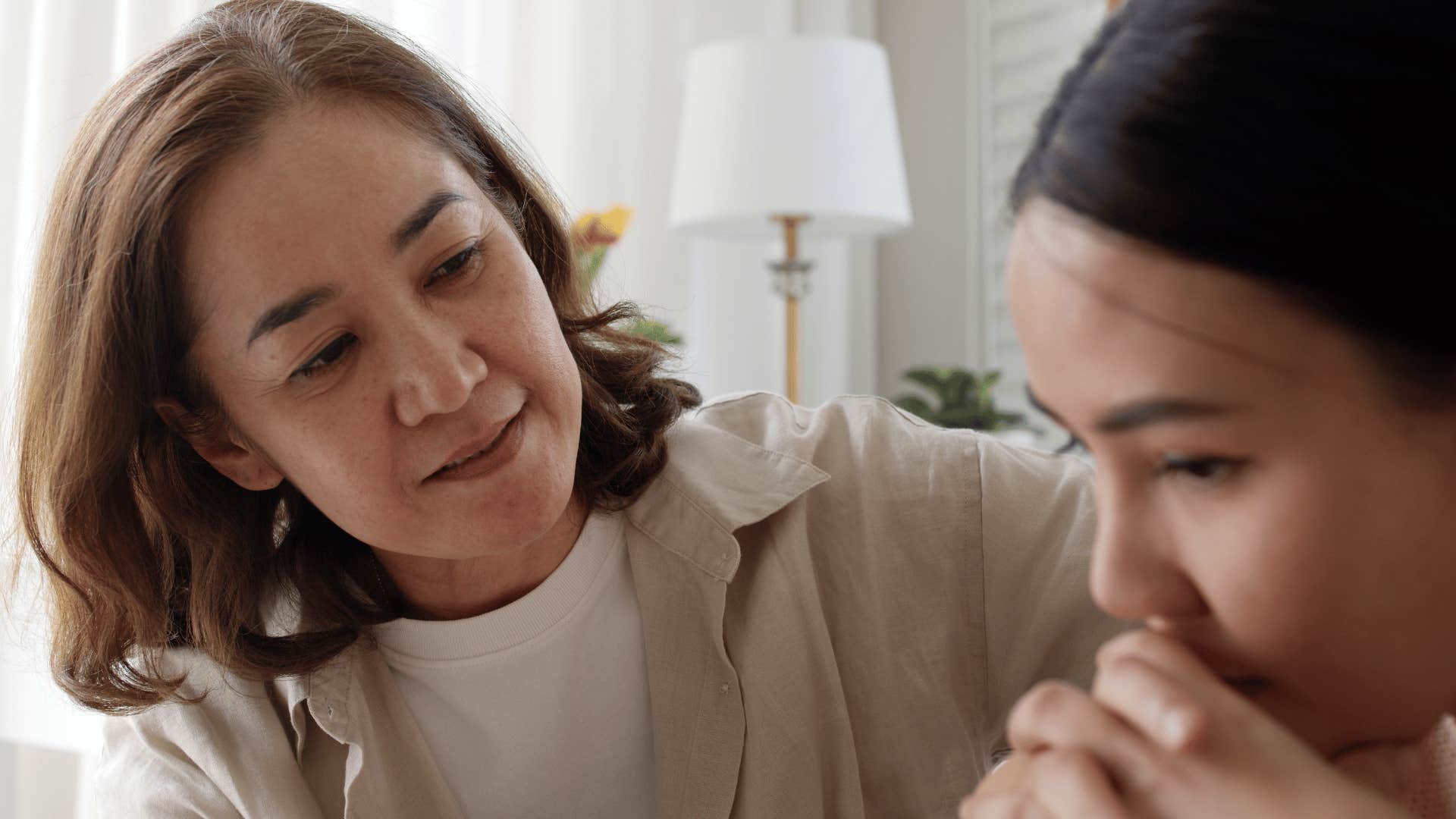 Woman who lacks empathy looking at her upset adult daughter.