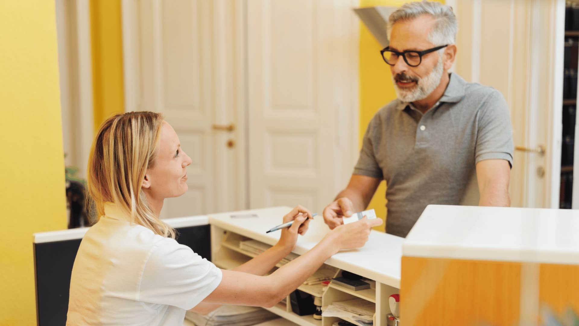 annoyed man having to pay at dentists office