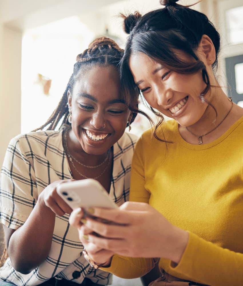 Two women laugh at how much dating apps suck