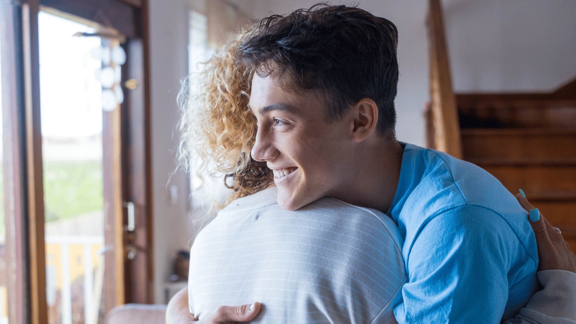 mom hugging her son after she explained not everyone will like him and that's okay