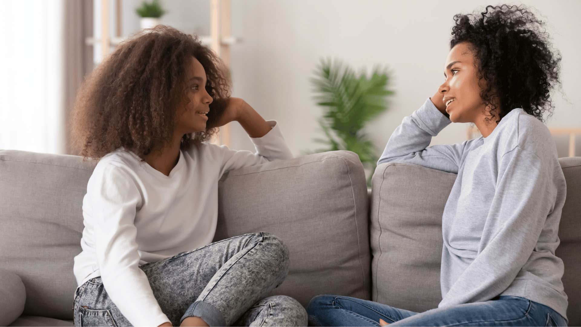 mother telling her daughter to start from the beginning on the couch