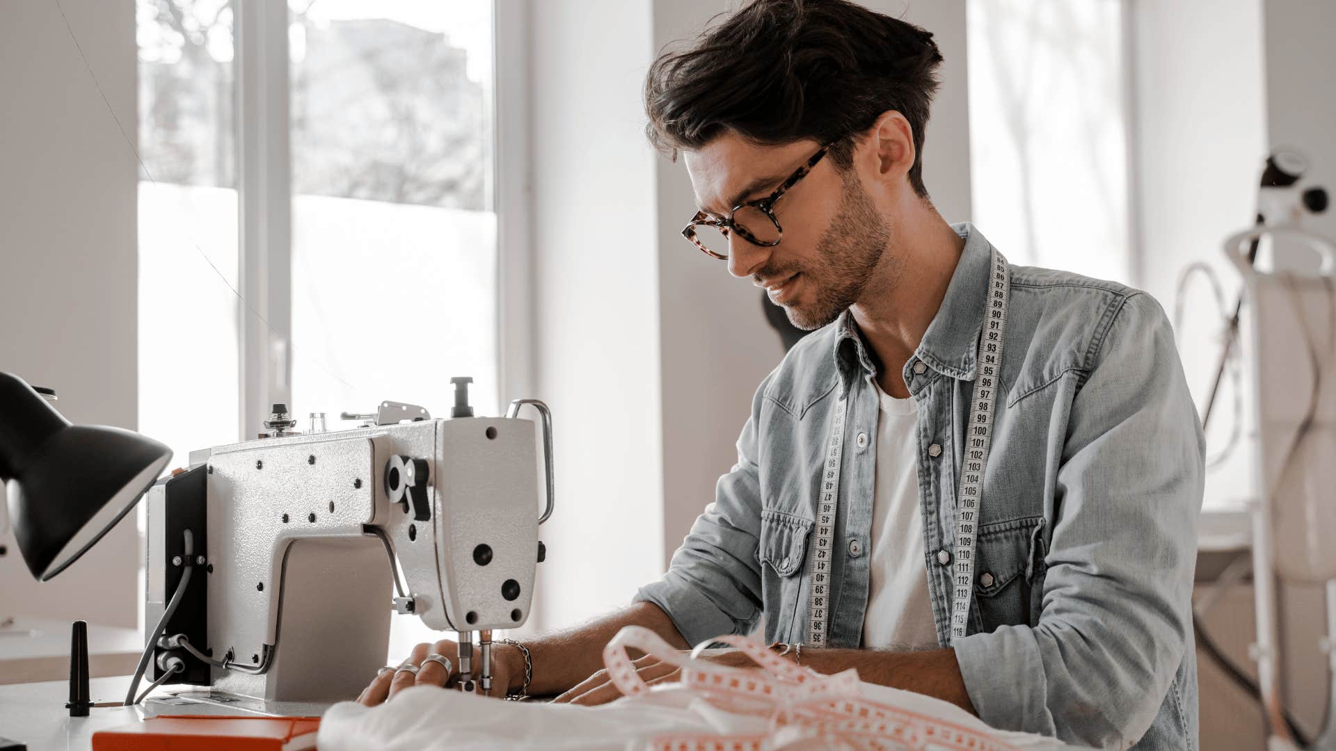gen z man using a sewing maching