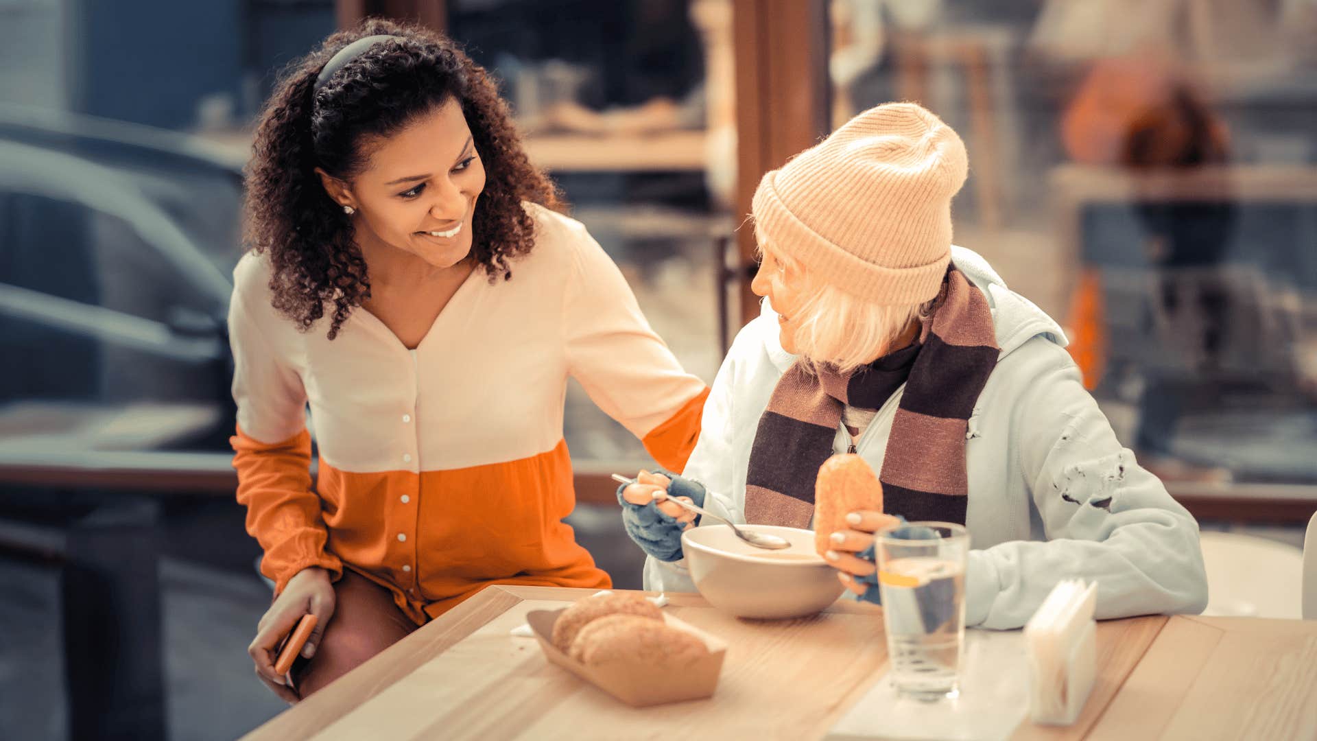 woman showing genuine kindness as she helps older woman
