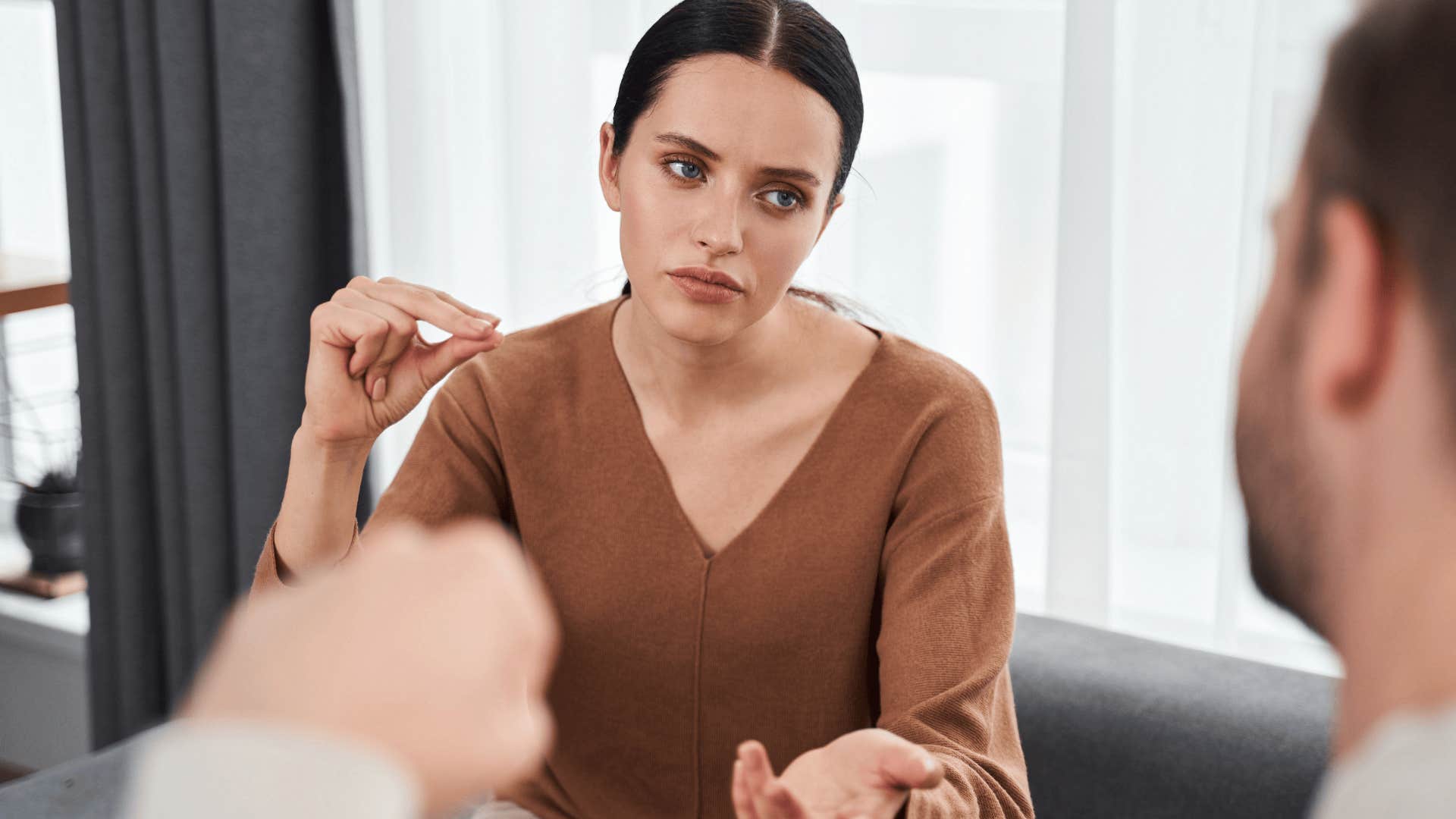 serious woman having a conversation with her partner