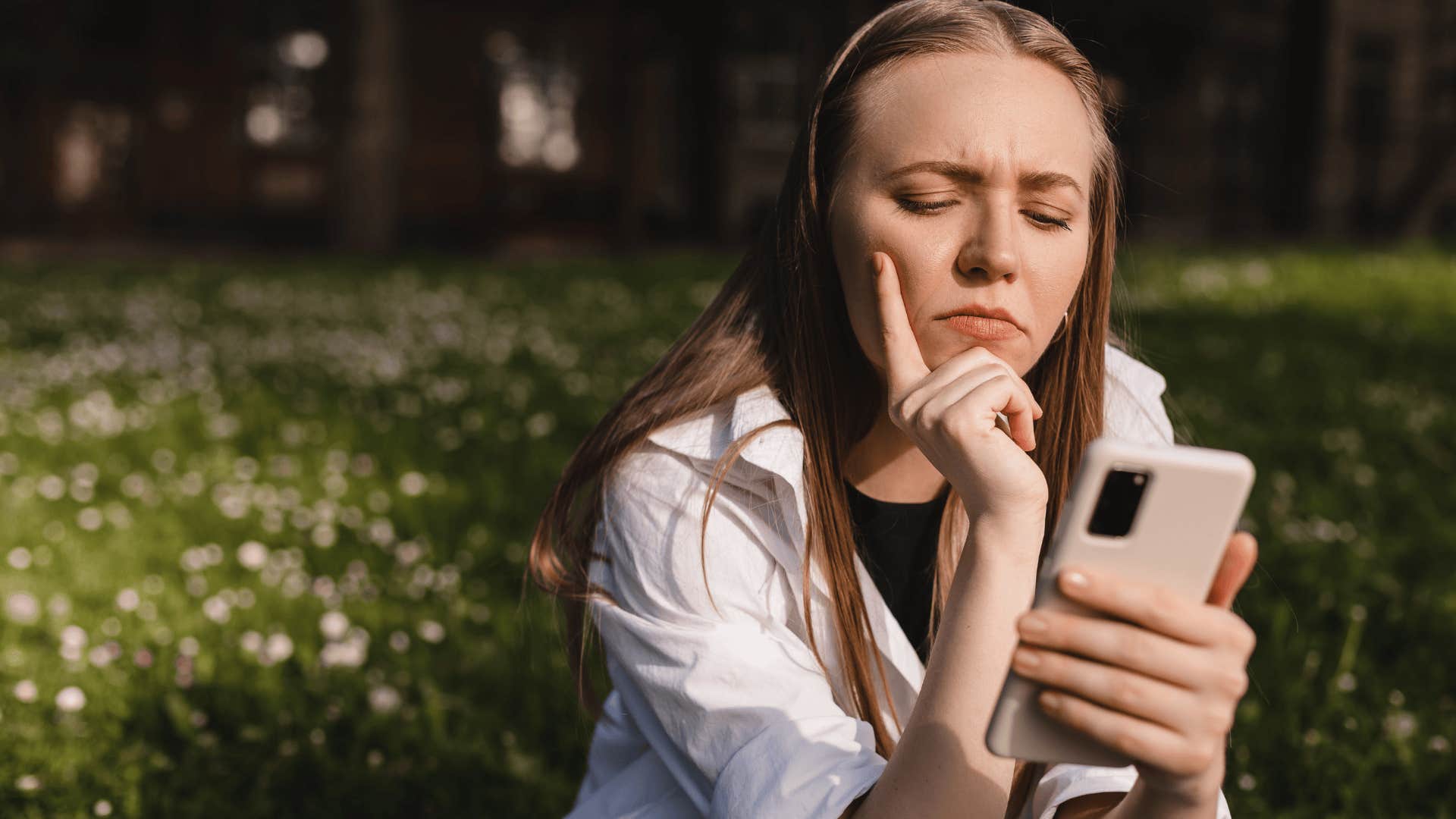 ypset woman texting on her phone outside