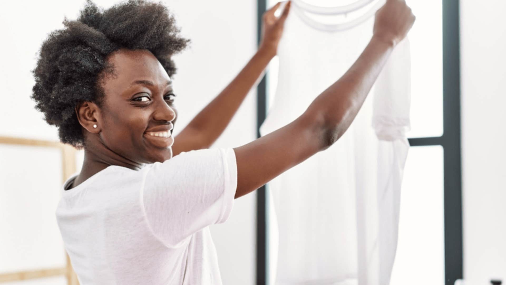 confident man hanging laundry