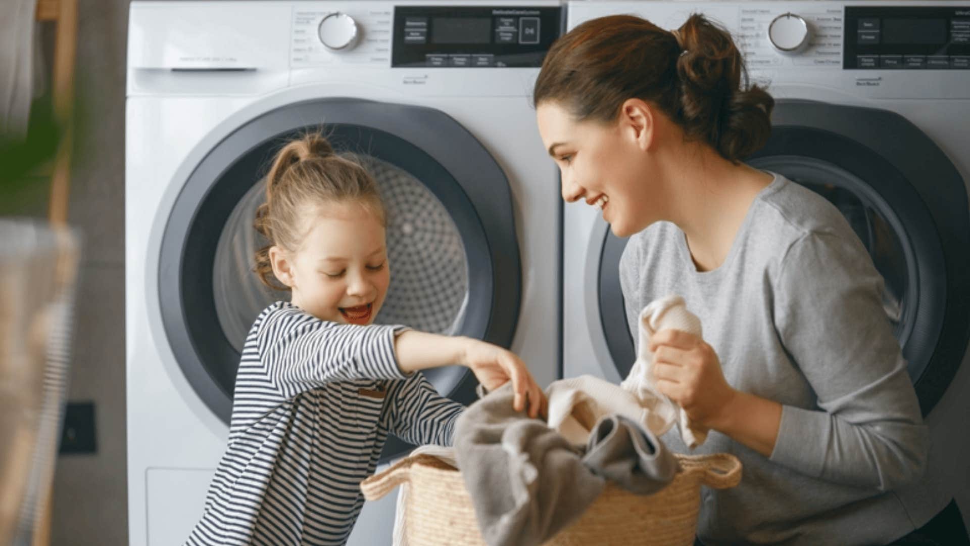 creative woman doing laundry with daughter