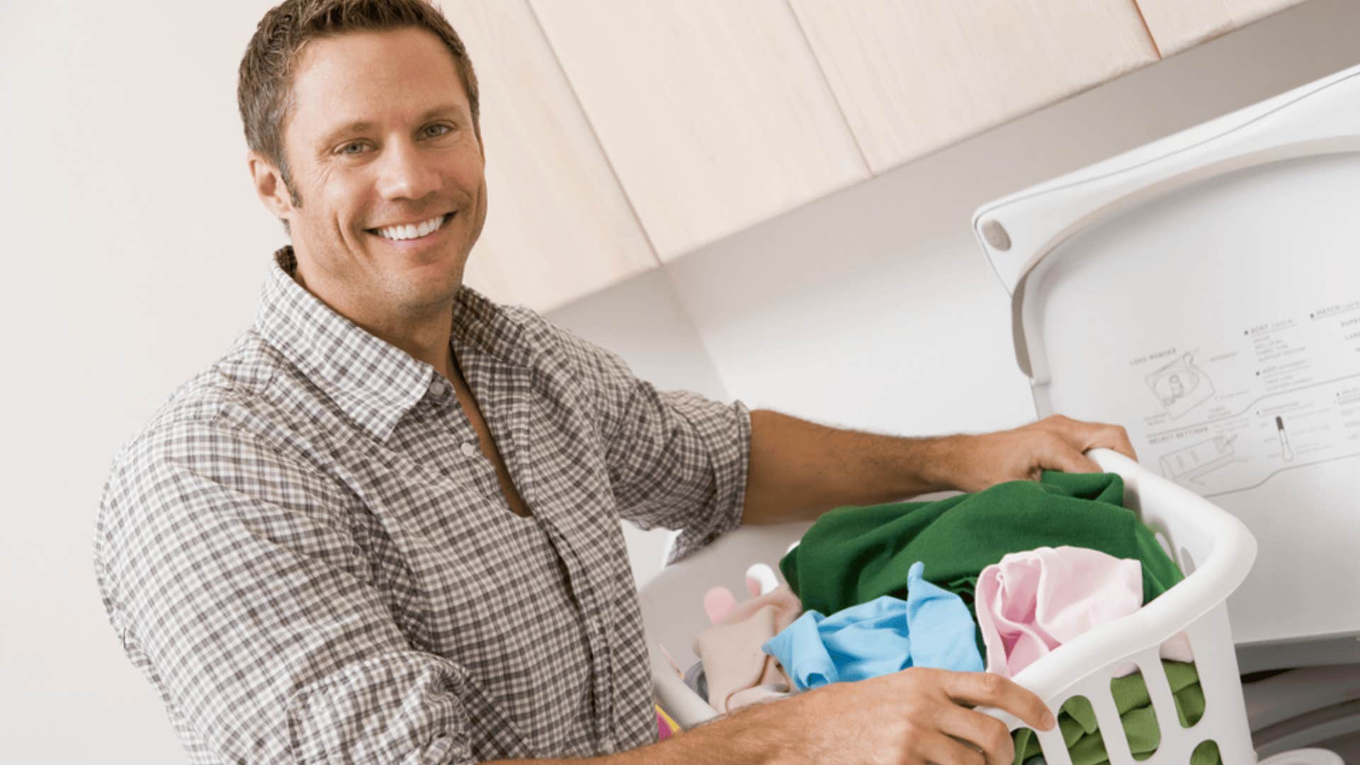 emotionally secure man holding laundry basket