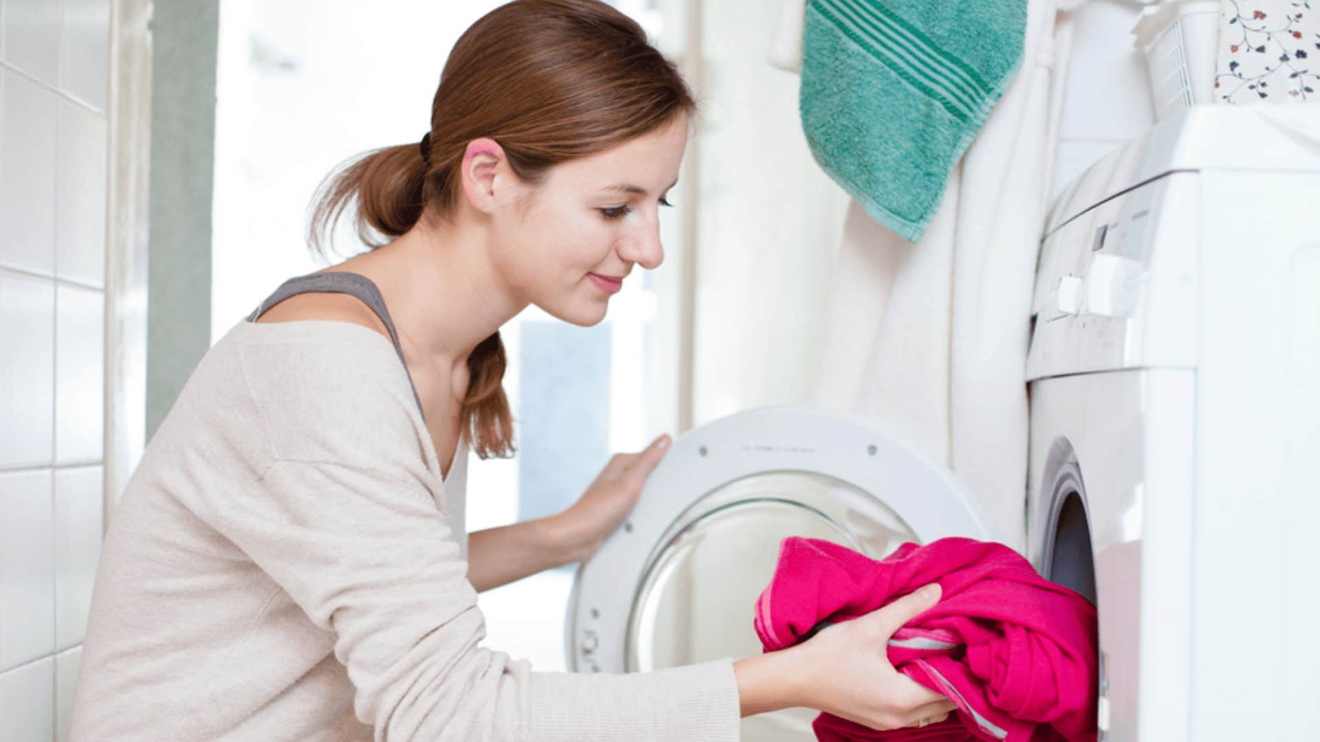 laid-back woman putting clothes in washer