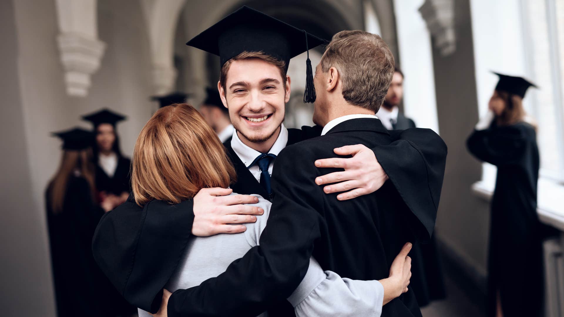 A man celebrates with his family and is proud of where he came from.