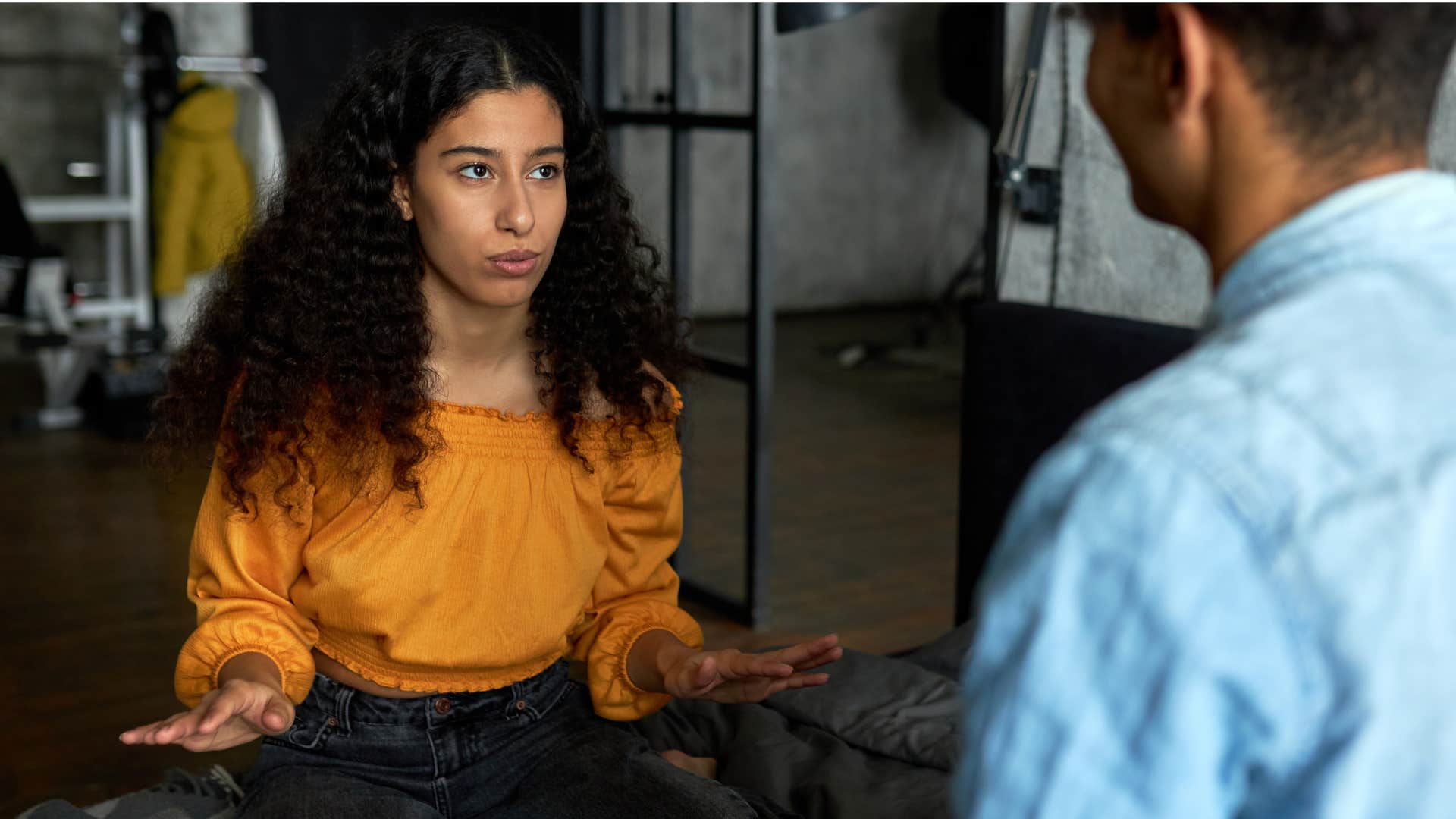 woman asking how long the event is going to be for to man in denim shirt