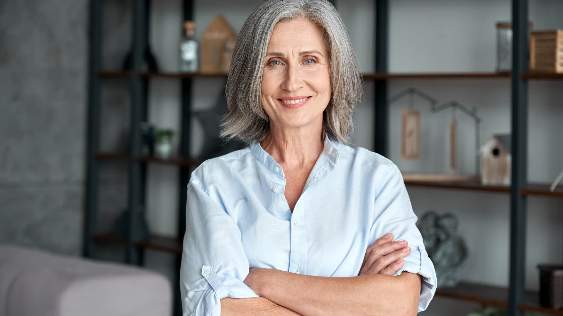 adaptable professional woman smiling with her arms crossed