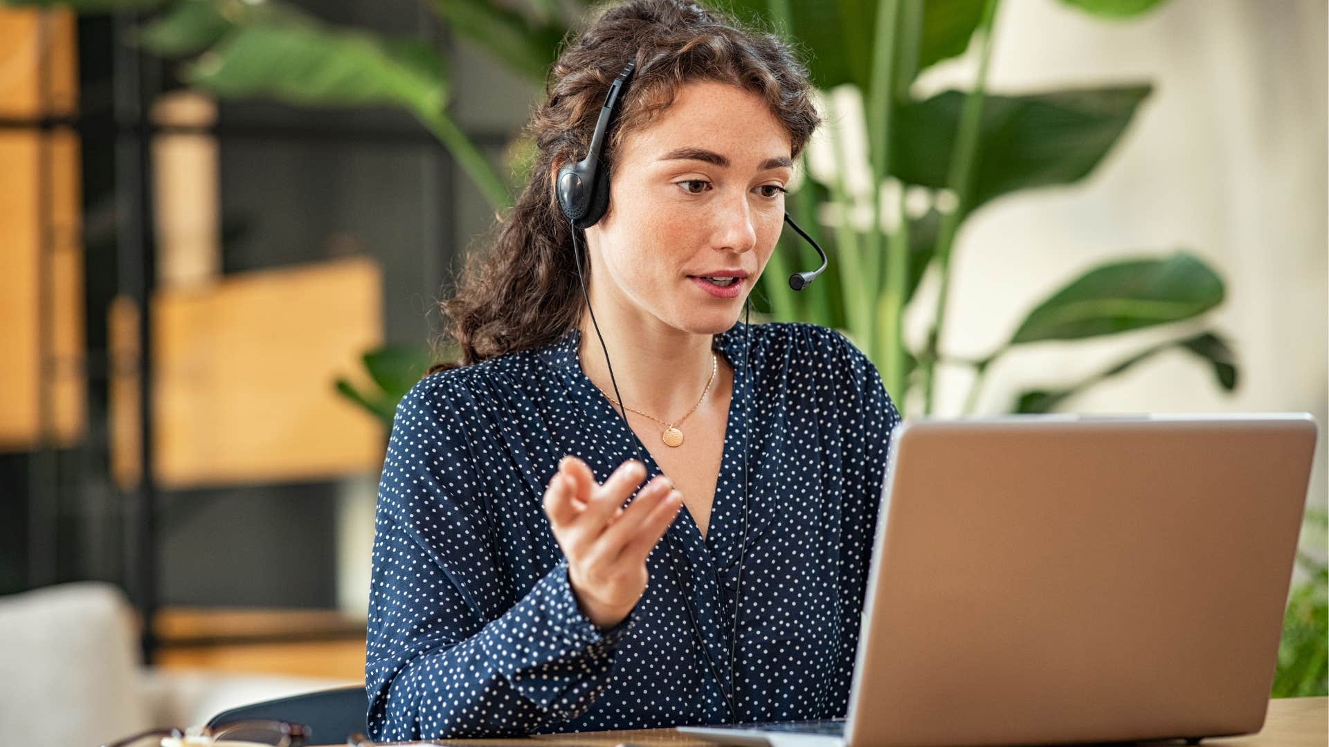 woman wearing headset talking to client