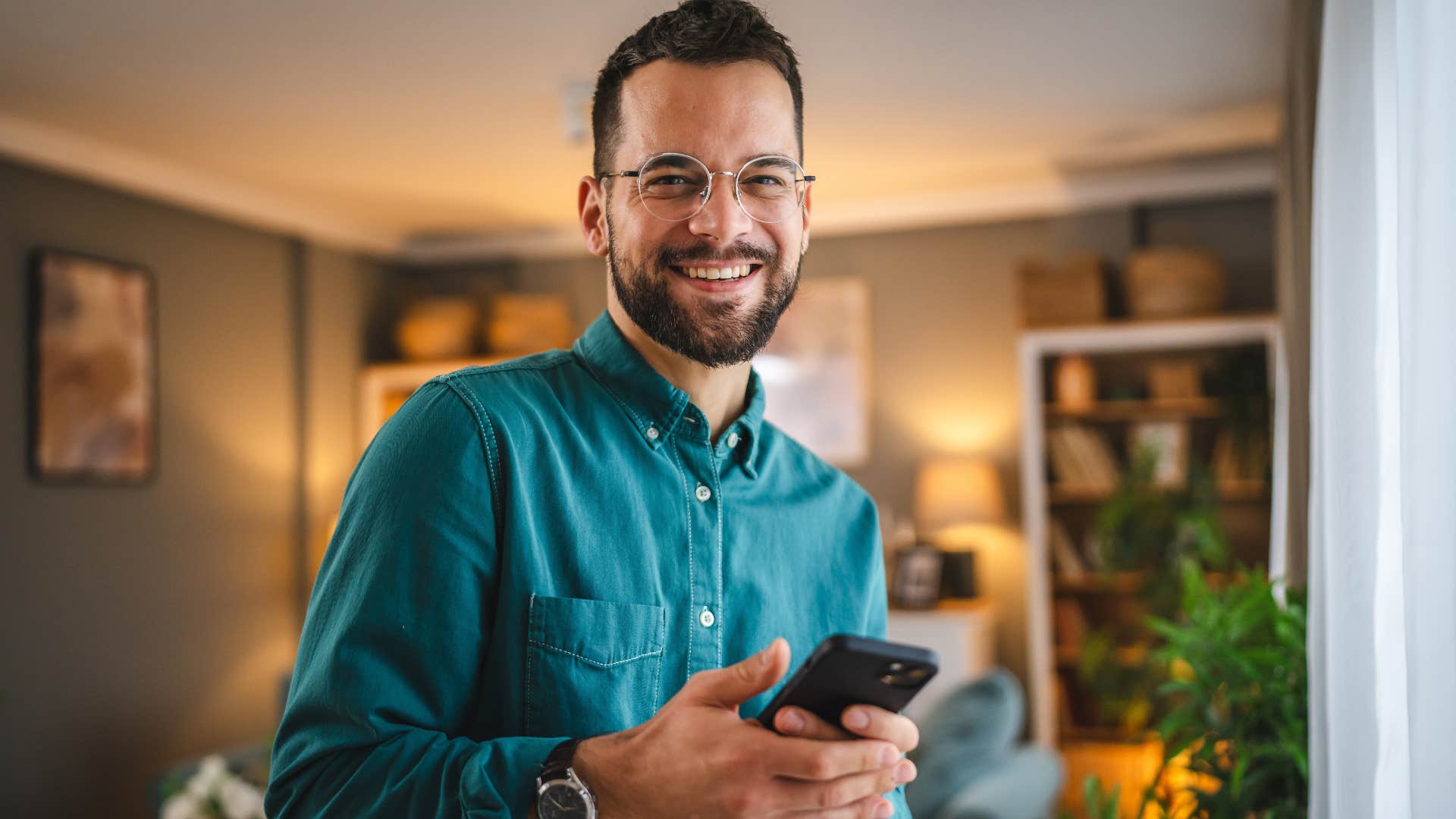 man with strong common sense smiling on his phone
