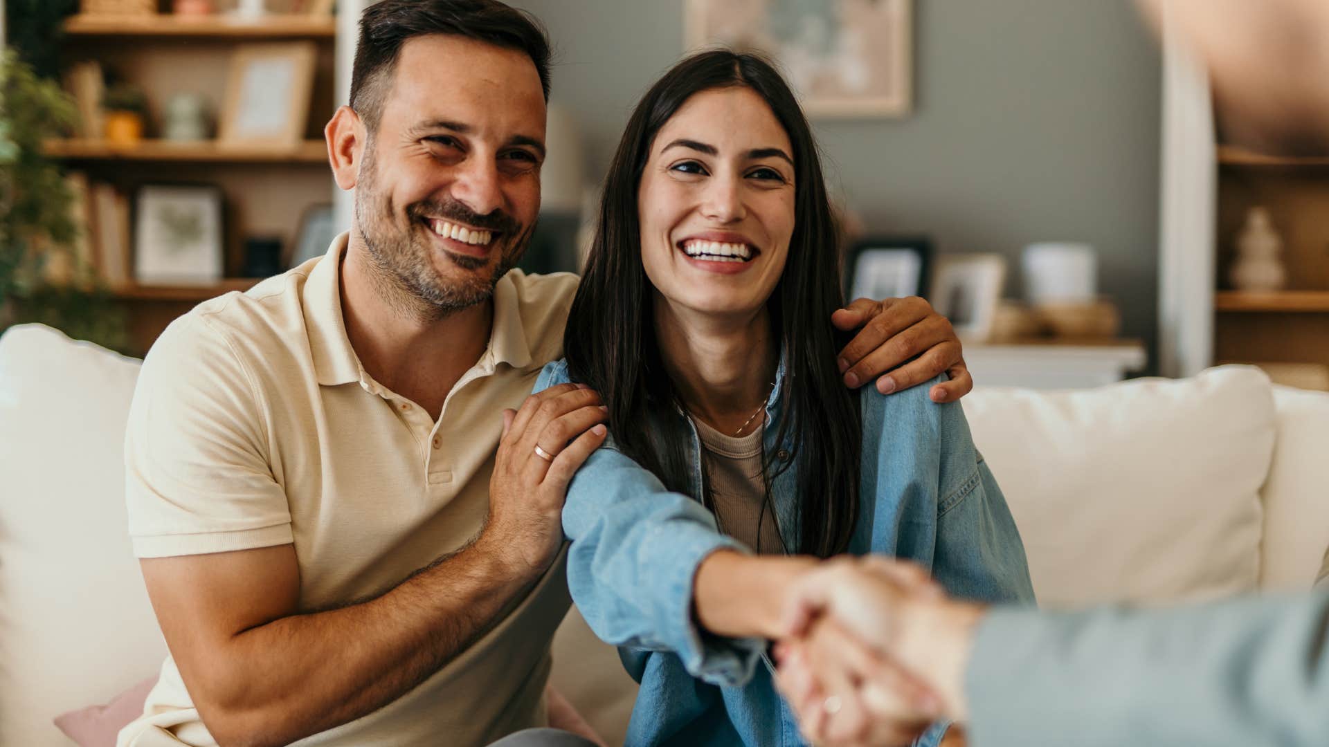 woman with strong social skills shaking hands with client