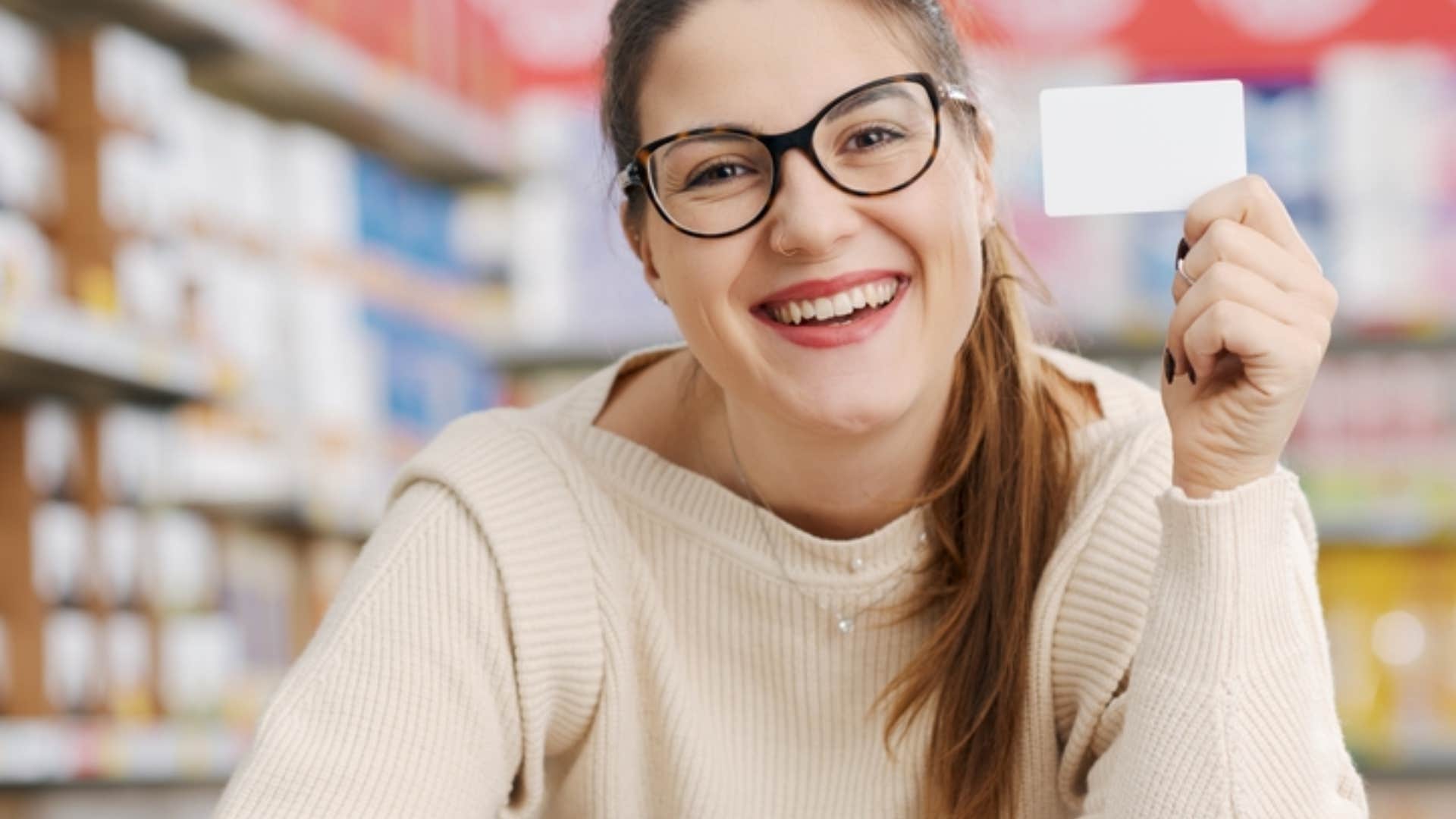 woman using rewards card wisely in store 