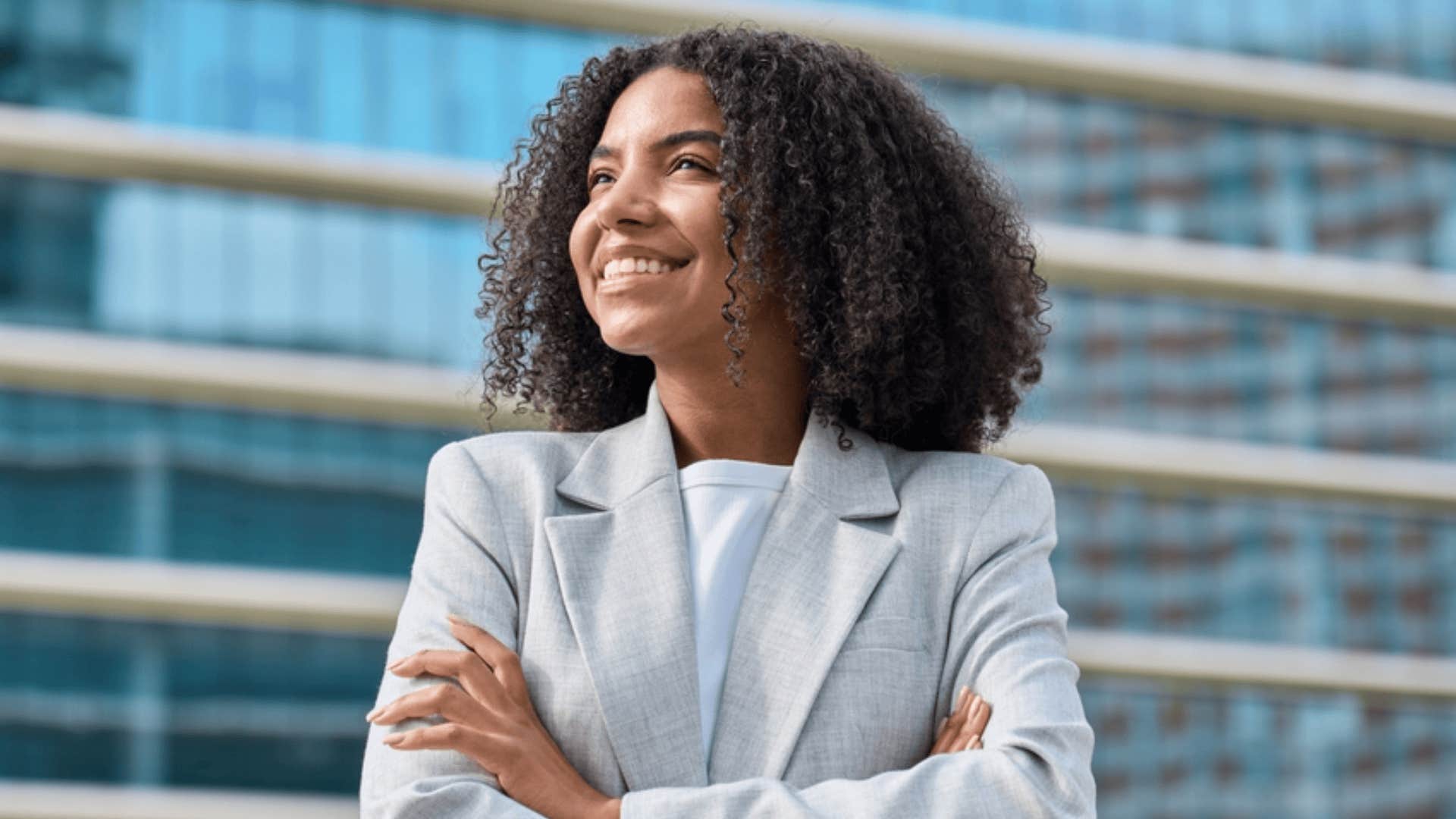 happy professional woman thinking about how far shes come