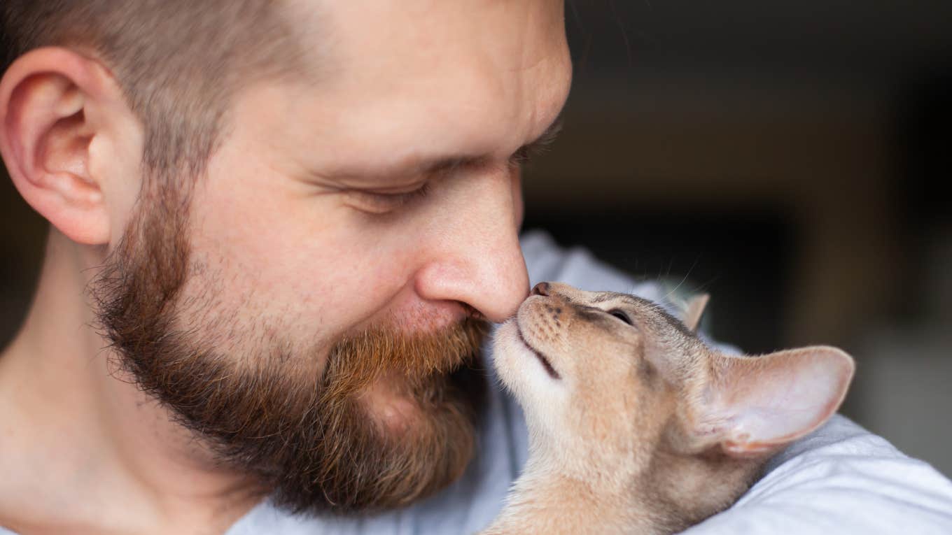 Man whose cat shows cute signs he is happy