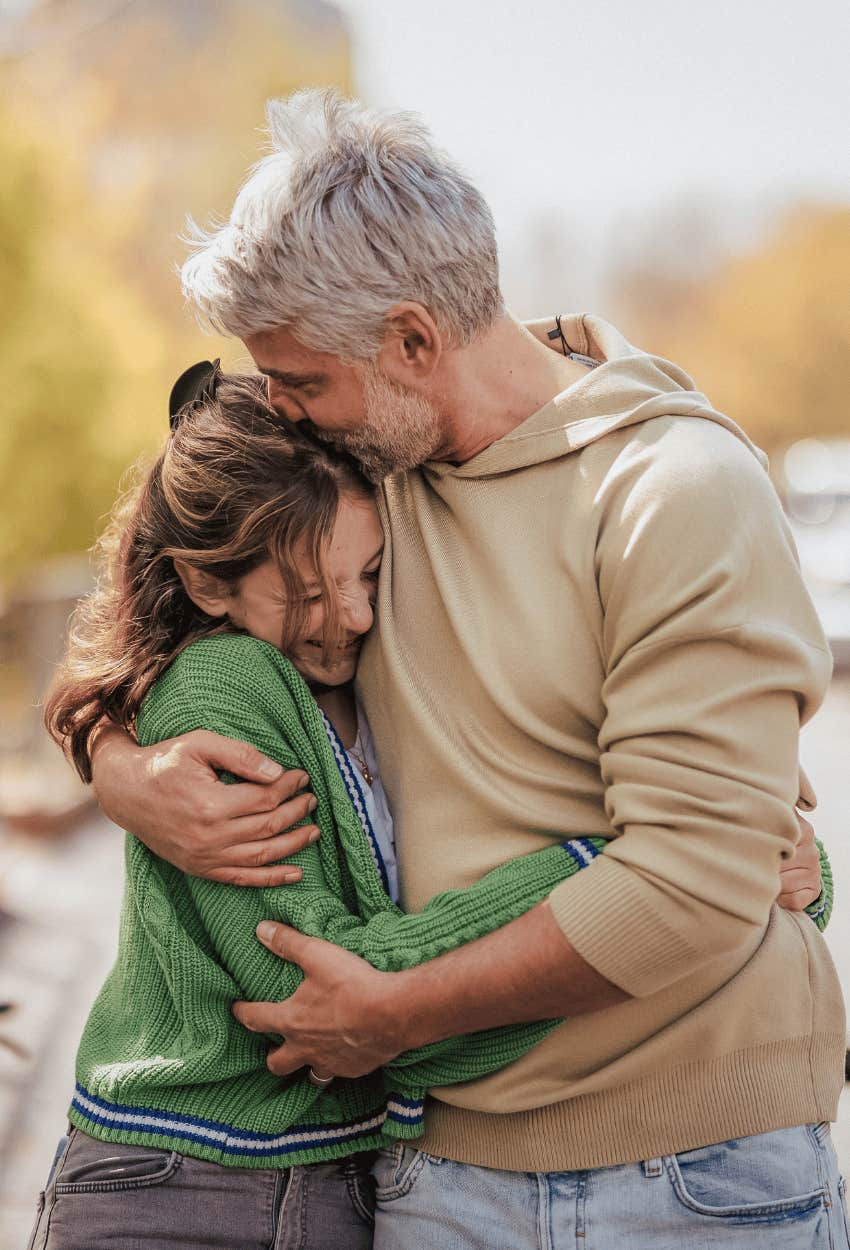 dad and daughter hugging