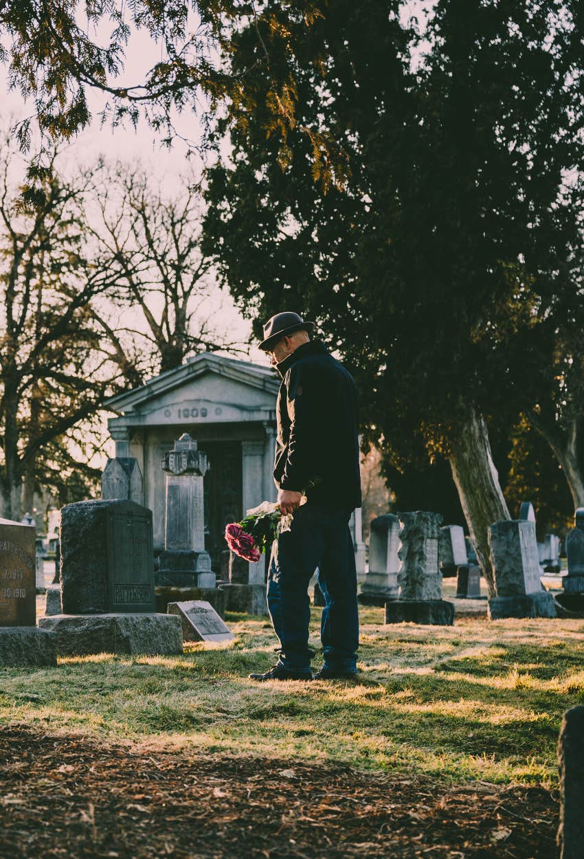 man visiting grave