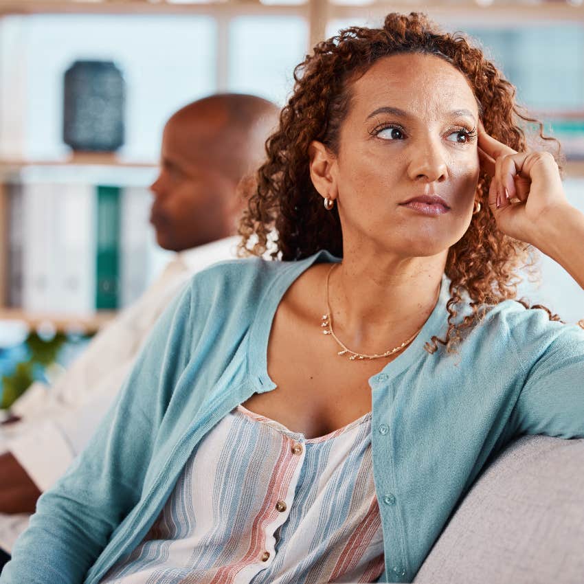 upset woman sitting next to man 