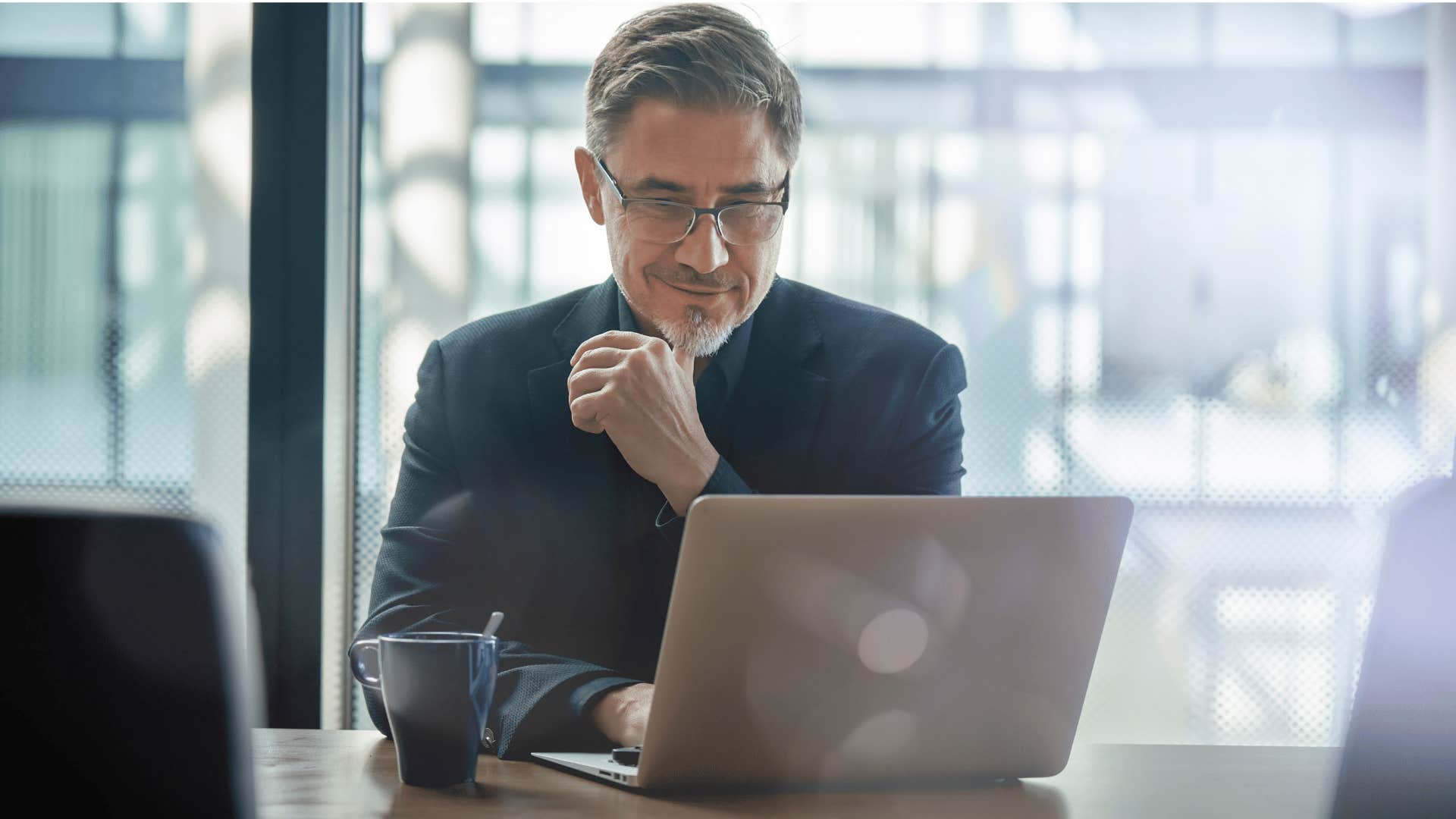 man in black shirt focused on his goals and staring at laptop