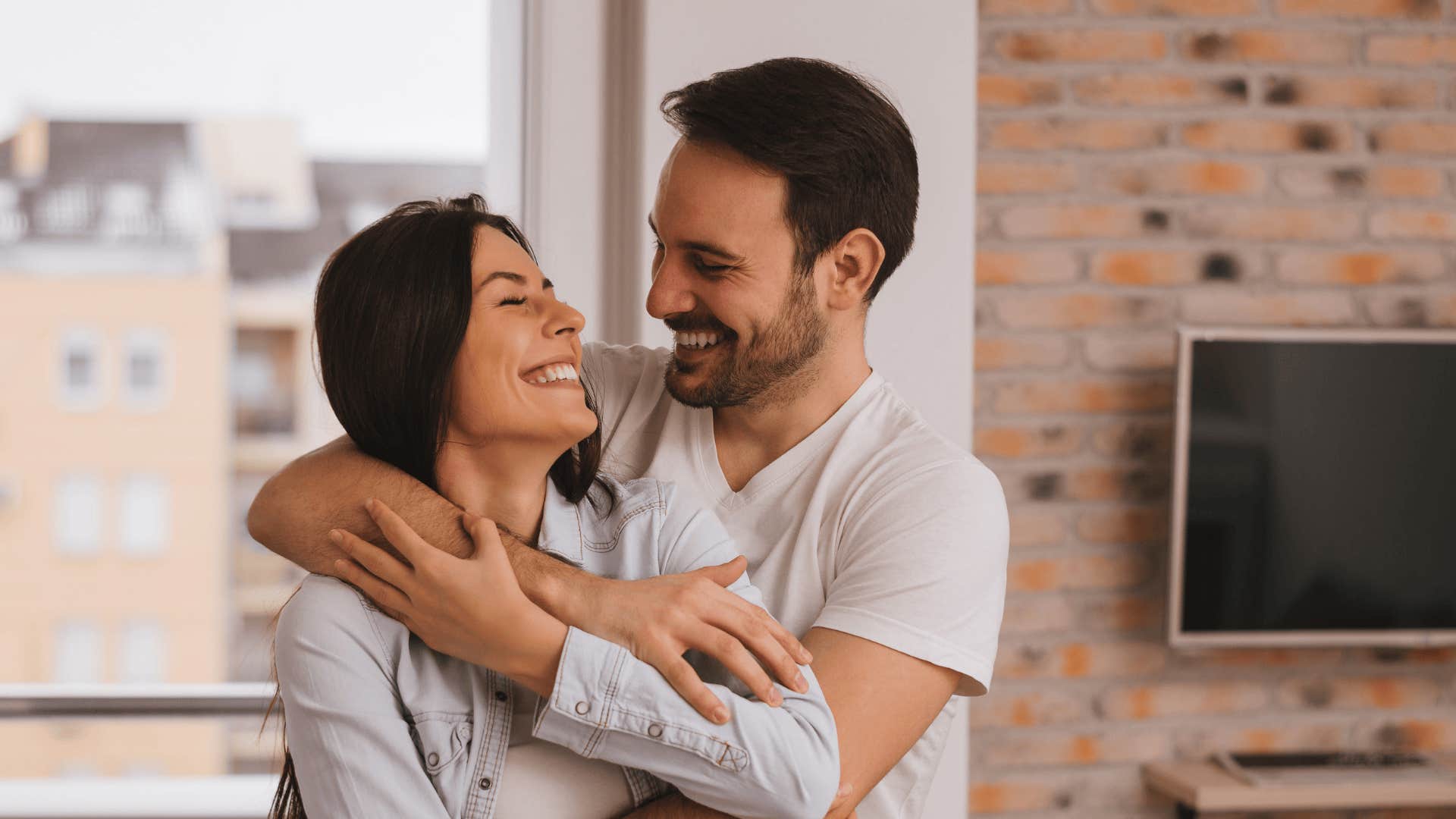 woman being hugged by man who has wmotional needs in the relationship
