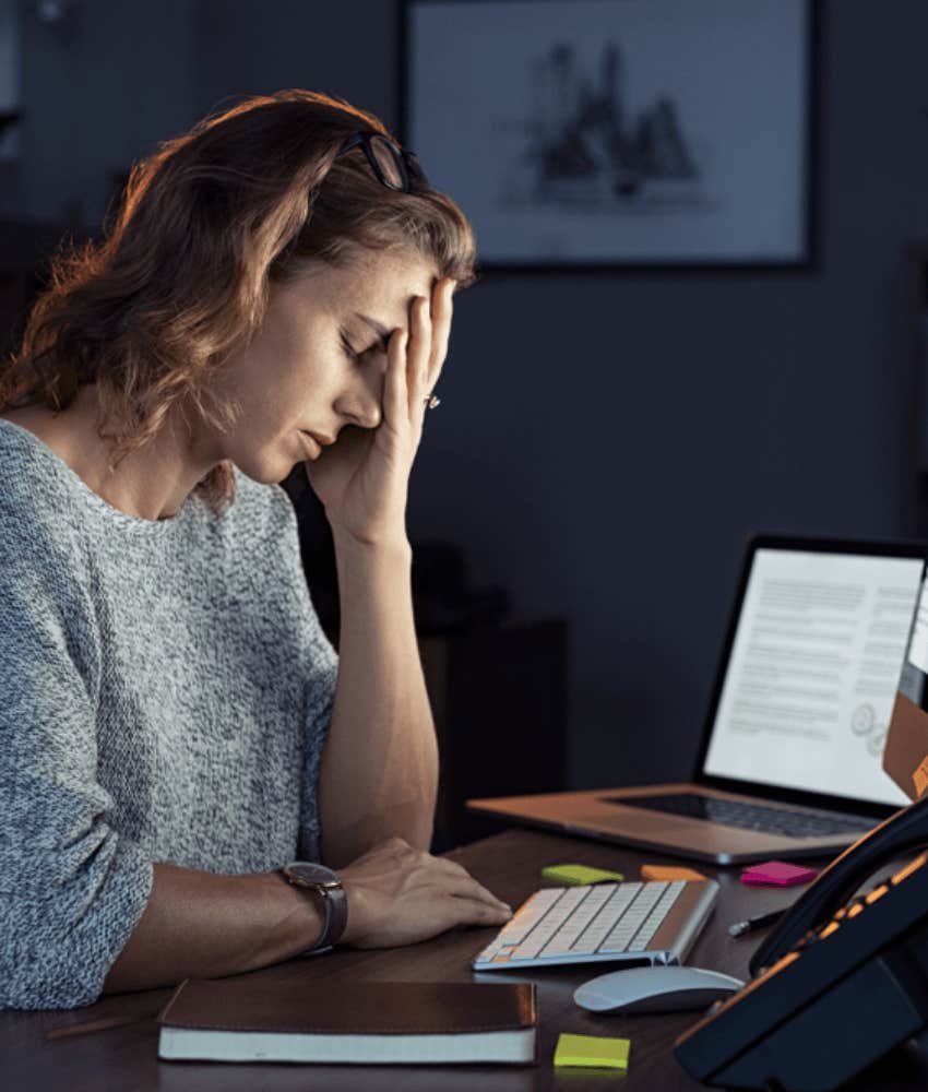 woman exhausted at work desk