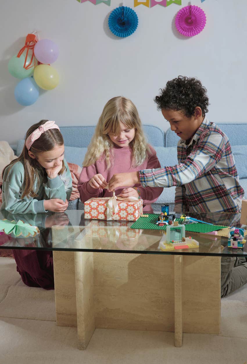 siblings opening birthday sister's gifts together as a way to learn empathy