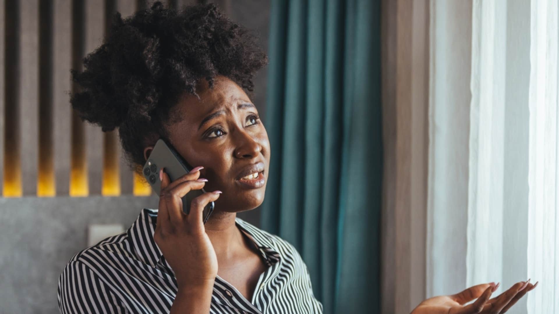 upset woman on the phone saying that's not fair 