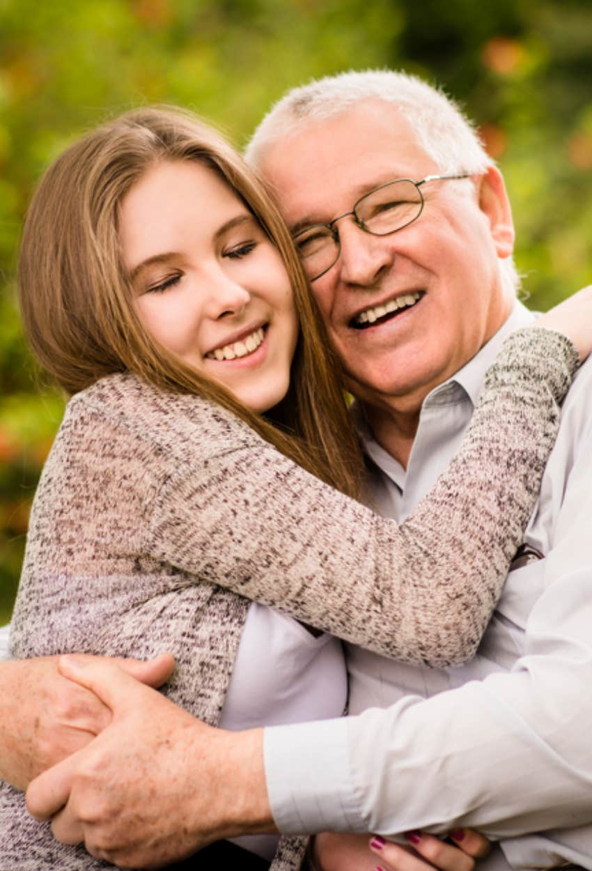 grandfather supporting granddaughter