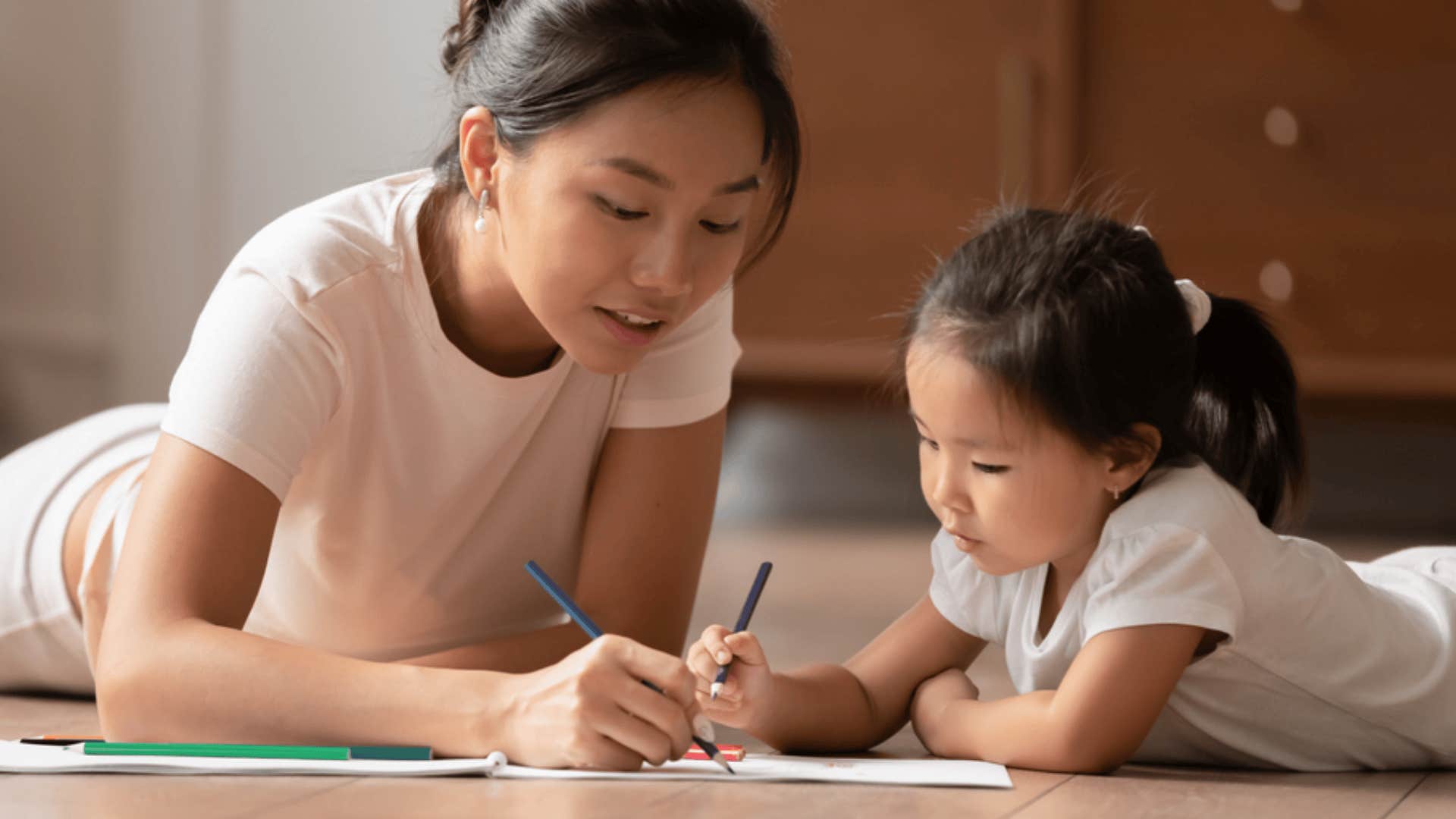 woman and daughter doing coloring book