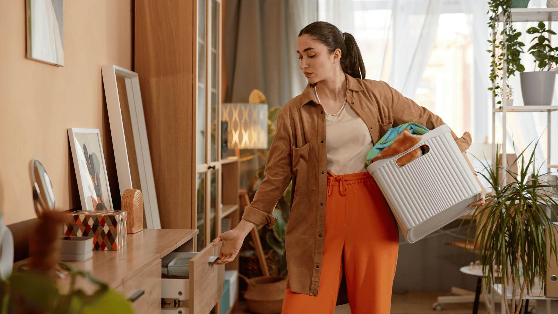 woman peeking in junk drawer to organize it