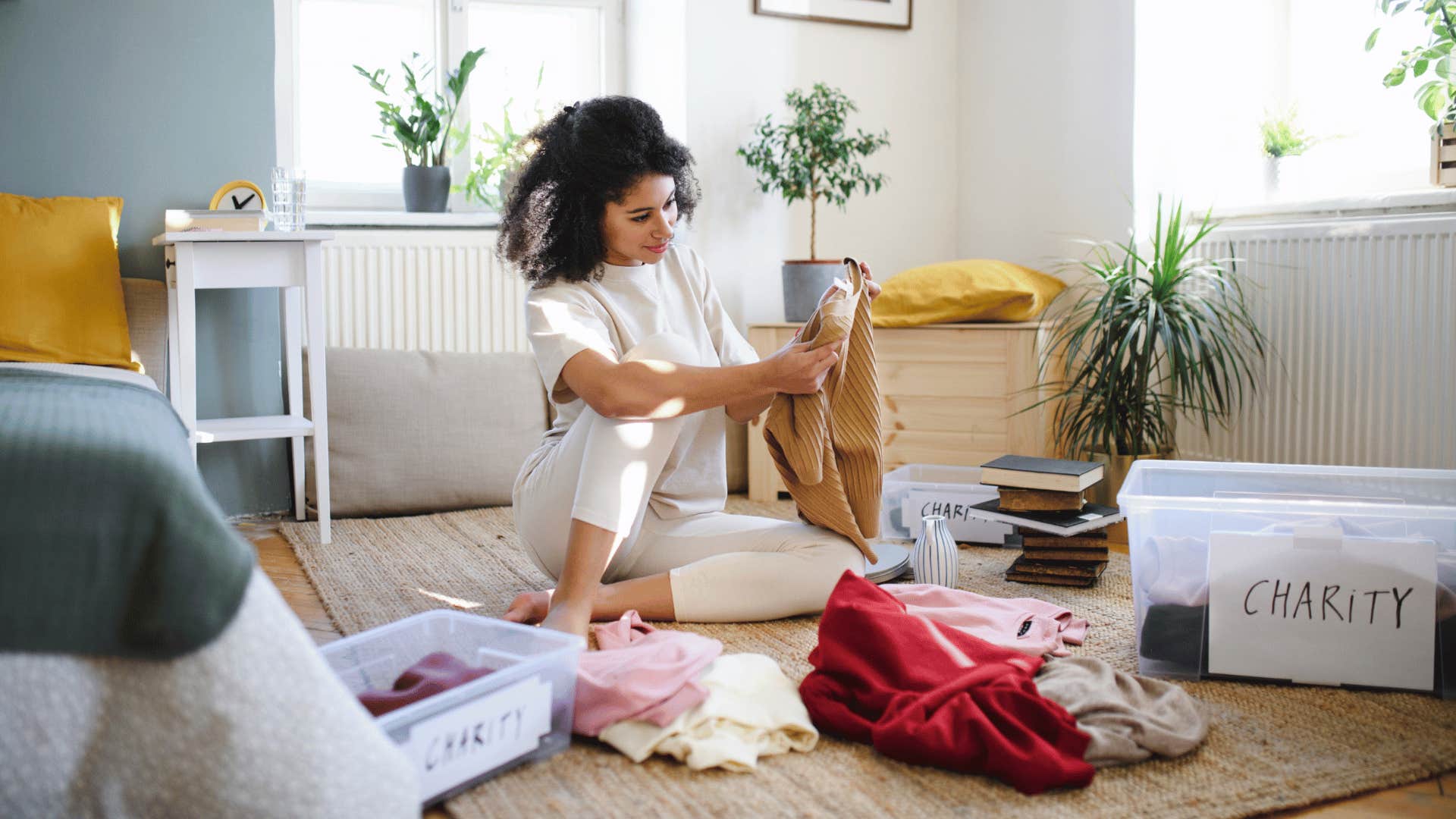 woman cleaning out her closet and clothes
