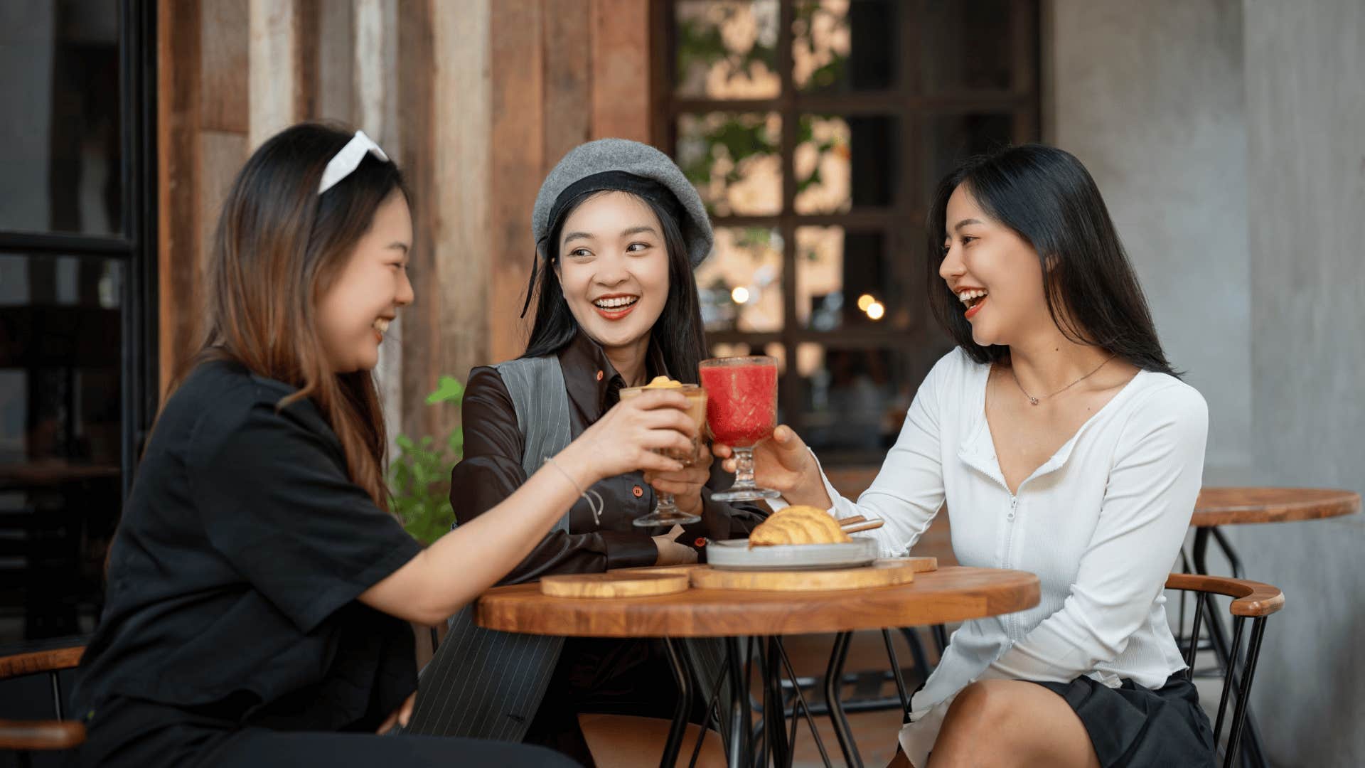 group of friends cheers drinks to celebrate new tradition 