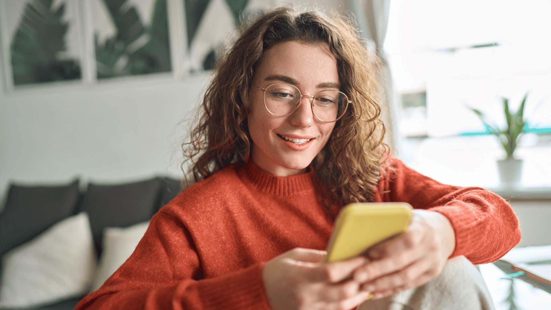 young woman on her phone unsubscribing from outdated subscriptions