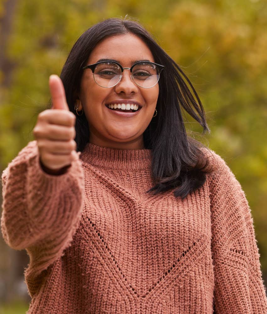 Happy woman gives big thumbs up of gratitude