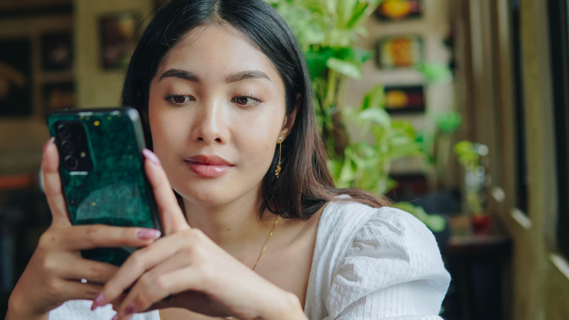 Woman building their identity around trends on their phone.