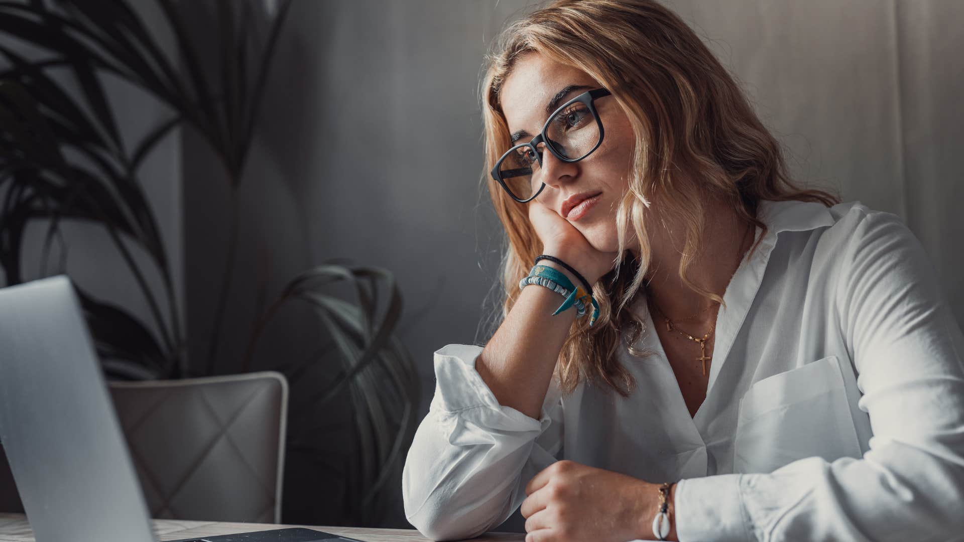 Woman giving too much power to their anxiety sitting at a desk.