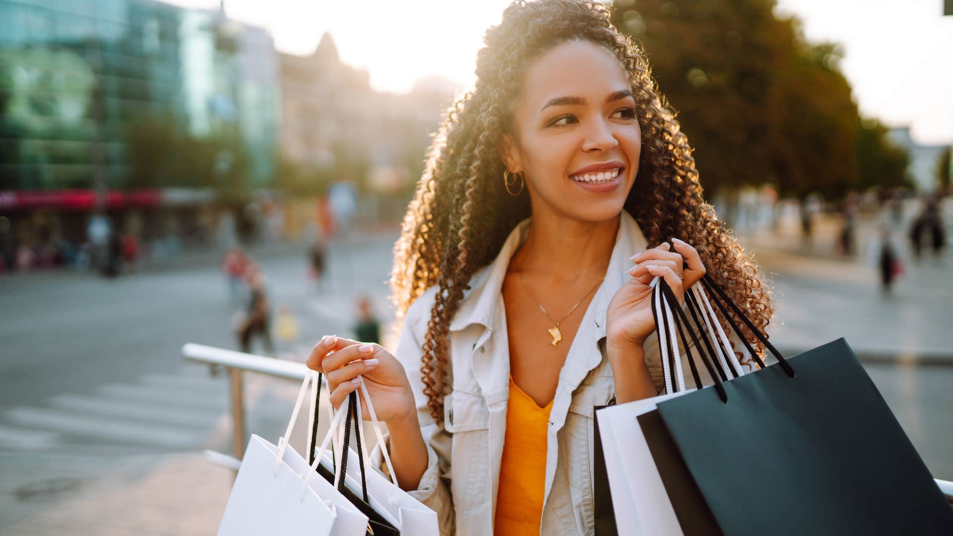 Woman doing retail therapy walking around with shopping bags.