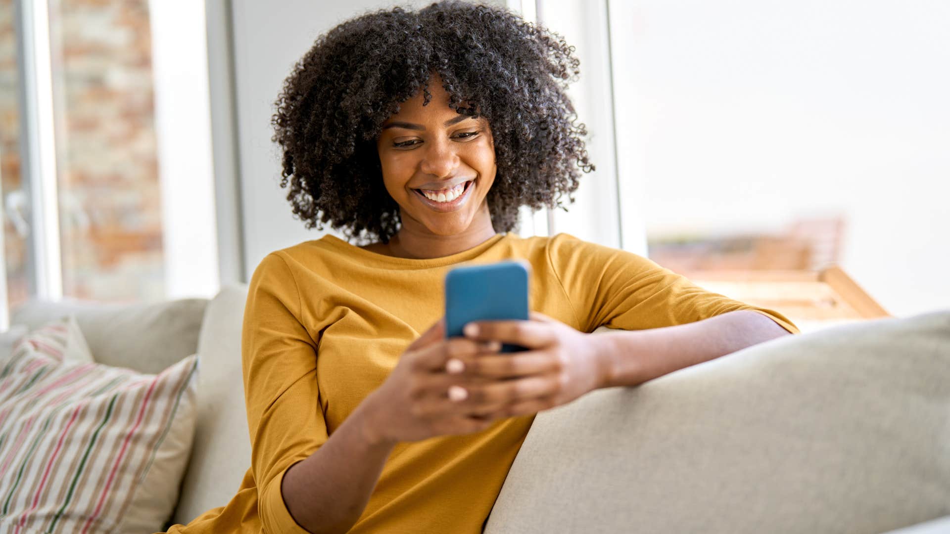 Gen Z woman spending too much time online on her couch.