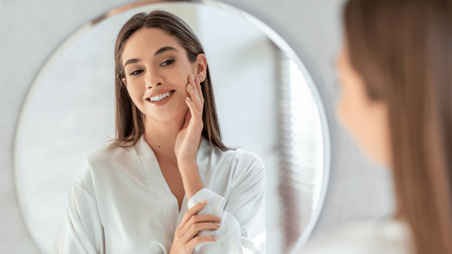 woman who will grow old and distant looking at herself in mirror
